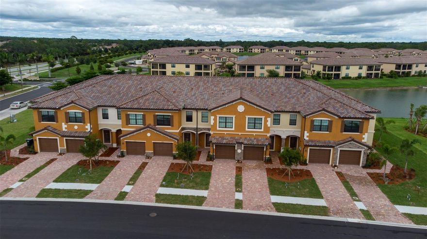 One or more photo(s) has been virtually staged. RESORT LIFESTYLE IN GATED COMMUNITY OF GRAN PARADISO ...NEWER IMMACULATE TOWNHOME IN GRAN PARADISO a Mediterranean style gated community which is part of the master planned community of Wellen Park. This townhome was built in mid-2022 has only been lived in part time and is like brand new. This home is on a lake with the best views. Large (1949 sq. ft.) 3 bedroom and 2.5 bath split level, with open concept on lower level. Resort lifestyle in a gated community with lots of amenities. The community's amenities include a large pool and deck, hot tub, a clubhouse, a library and meeting rooms, lifestyle events and classes, gym, men's and women's locker rooms with wet and dry saunas, private massage rooms, table tennis, tennis, pickle ball and basketball courts, playground, and miles of sidewalks for walking. There are a lot of activities and events, and the association has a lifestyle director.  HOA monthly assessments cover maintenance and insurance of exterior and roof, lawn maintenance, irrigation, tons of amenities, trash and recycle, cable and internet by Hotwire Fision. Hurricane shutters for all windows and sliding and front doors included. Smoke and pet free home.  This townhome is the newest one on the market and has the best location looking onto lake and preserve and not at other townhomes and not on Highway 41 and the noise. Easy access in and out of community. Close to shopping centers, and beaches. Many beaches are close by - multiple beaches are 15 to 30 minutes away. Great access in and out of community and to Highway 41 and Interstate 75. SELLER IS MOTIVATED AND SELLER IS TAKING OFFERS....