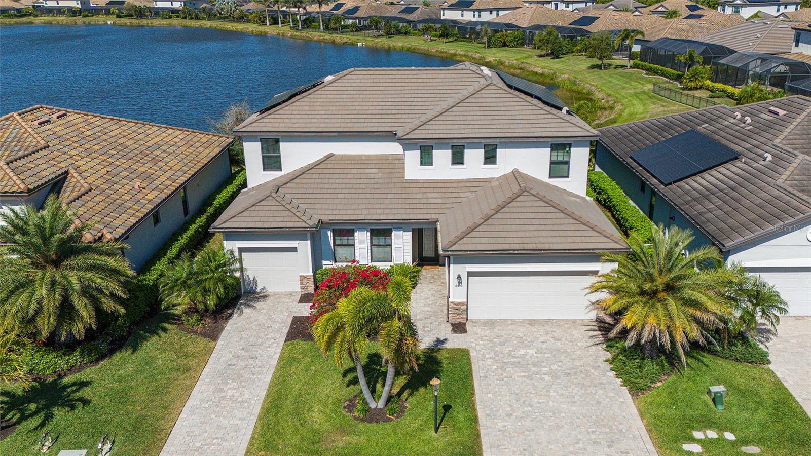 STELLAR NEW PRICING- GENERATOR/ SOLAR POWER ASSIST/ IMPACT WINDOWS 2nd LEVEL. COME SEE THE DIFFERENCE. Welcome to Polo Run, a premier gated Lakewood Ranch community! This stunning lakefront home offers a versatile floor plan with separate apartment/suite space which is ideal for multi-generational families or the ultimate space for working from home! The dual garage layout also allows for the ultimate in flexibility. This home offers six bedrooms, four and a half bathrooms, and over 3,900 square feet of refined living area. Major selling points are the whole home gas generator, solar panels to help with electricity costs, impact glass windows installed on the second level, and a gas heated pool and spa with forever views. The primary suite is located on the second level and has abundant space for privacy and convenience. The main living level features beautiful diagonally-laid tile, an electric decorative fireplace, and lots of beautiful trim work. The open concept kitchen features granite countertops and stainless steel appliances. The balance of this amazing and spacious home allows for an abundance of uses with plenty of spare bedrooms and space to utilize! Polo Run features great amenities including a community resort-style pool, tennis and pickleball courts, bocce ball, dog park, basketball and on-site fitness center! The feel of the community is amazing with spacious water vistas and sidewalk lined streets. This unique home is truly a special opportunity, schedule your private showing today!
