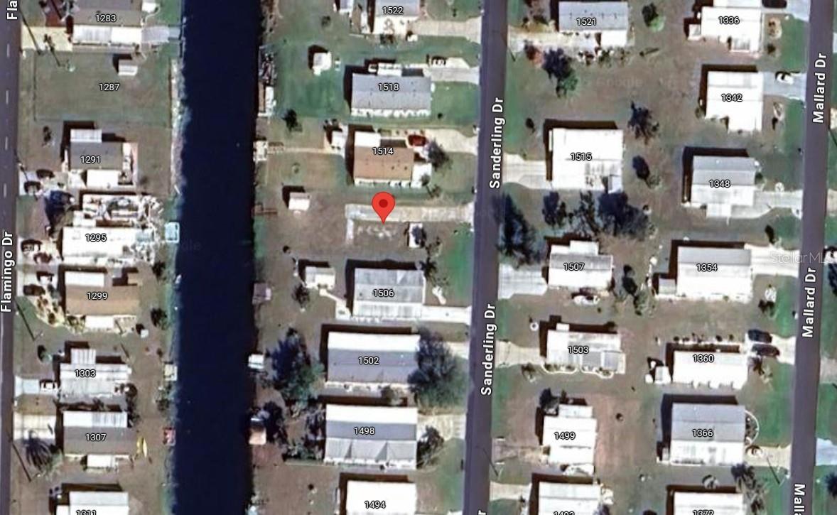 WATERFRONT Vacant land ready for your new home located in Holiday Mobile Estates 55+ Community. Enjoy fresh water fishing from the canal with a private wood dock and a preexisting shed to store all your outdoor equipment. Join the Edgewater club and become an part of an active community that offers many amenities including a clubhouse, pool, tennis, pickle ball, horseshoes and much more! Conveniently located near shopping, fine & casual dining spots, LIVE entertainment, biking, and boating. JUST A SHORT CAR RIDE to the Gulf Beaches of Lemon Bay, Englewood, Boca Grande, or Manasota Key to name a few where you will find world class fishing.