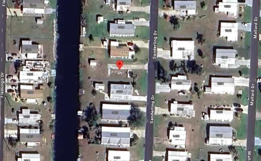 WATERFRONT Vacant land ready for your new home located in Holiday Mobile Estates 55+ Community. Enjoy fresh water fishing from the canal with a private wood dock and a preexisting shed to store all your outdoor equipment. Join the Edgewater club and become an part of an active community that offers many amenities including a clubhouse, pool, tennis, pickle ball, horseshoes and much more! Conveniently located near shopping, fine & casual dining spots, LIVE entertainment, biking, and boating. JUST A SHORT CAR RIDE to the Gulf Beaches of Lemon Bay, Englewood, Boca Grande, or Manasota Key to name a few where you will find world class fishing.
