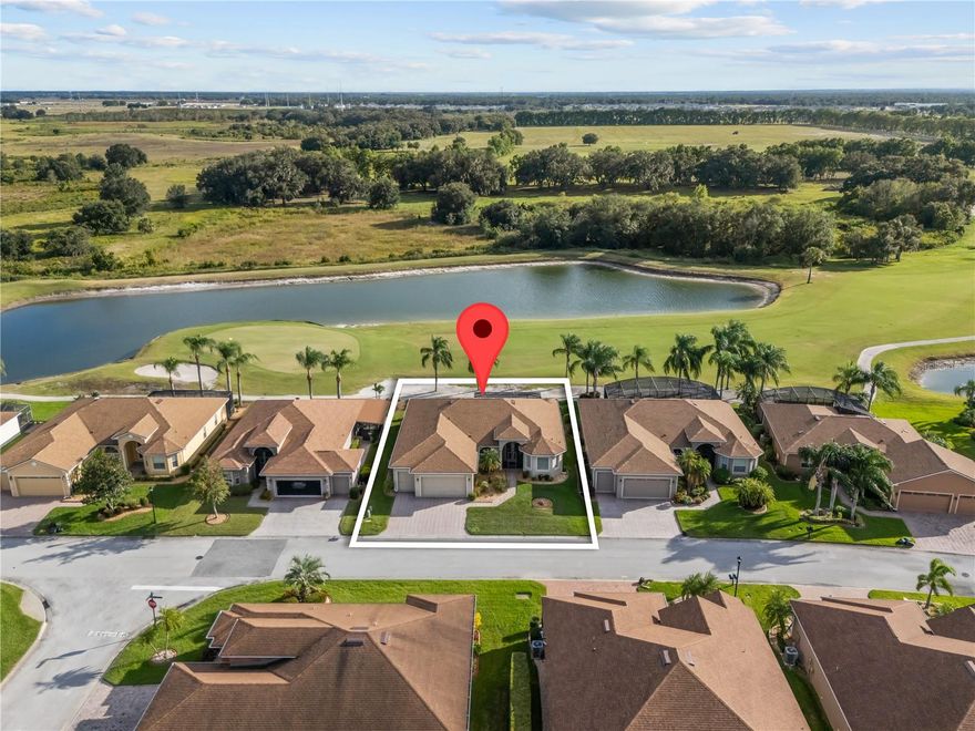 Lake Ashton is a 55+ golf community with all the amenities you could ask for including movie theatre, bowling alley, pickle ball, tennis, bocce, fitness centers, two clubhouses and so much more!  This highly upgraded 3-bedroom, St John floor plan home is breathtaking! Once inside the elegant beveled double French glass door entry you will be amazed at the impeccably executed home finish.  Such as, round columns frame the dining area, while raised archways lead to the kitchen and breakfast nook. The great room features coffered ceilings with recessed lighting, 8’ triple sliders that open to the lanai, a ceiling fan, and crown molding that flows throughout the home. The kitchen boasts a bank of drawers, 42" raised-panel custom cabinets with crown molding, stainless steel appliances, granite countertops, pendant lighting, and a breakfast bar.  This home has split plan for privacy.  Wake up to serene views from your primary bedroom, complete with sliding doors to the lanai. The en-suite bath features two walk-in closets, a walk-in shower, double vanities, a soaking tub, and a linen closet.  The large, screened lanai overlooks the 13th hole has pond and nature views.  There is also the Health and Fitness center which has an indoor pool, sauna, racquet ball and basketball, for your enjoyment. There are so many more amenities, clubs, activities, dances, and entertainment.  Don't miss out on the opportunity to live in Lake Ashton, Central Florida's premier 55+ active adult resort style living community. This is a must see to appreciate home and community!