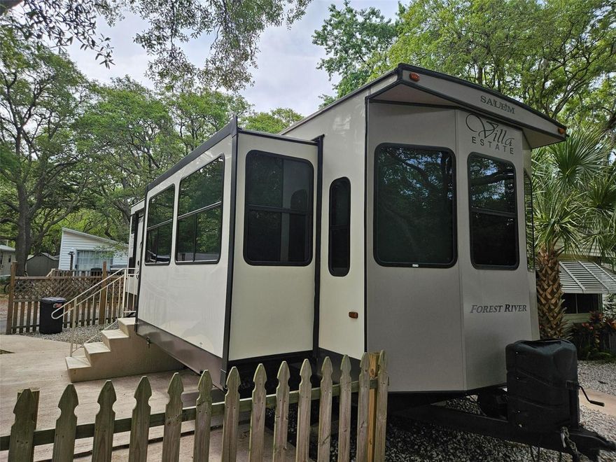 YOU OWN THE LAND!  Great for short term rental or snowbirds!  This beautiful, 2020 Forest River Salem Destination trailer is situated on a very quiet lot in the back of the community.  The trailer is hard plumbed for ease of use.  There is a master bedroom with queen bed, a pull out queen sofa in the living room and two twin mattresses in the sleeping loft.  The washer and dryer are located in the shed,  There is fencing for added privacy.  Furnishings for the short term rental are negotiable.  Currently rented as a short term vacation rental on Airbnb and VRBO.  Don't miss out on this fantastic investment opportunity!