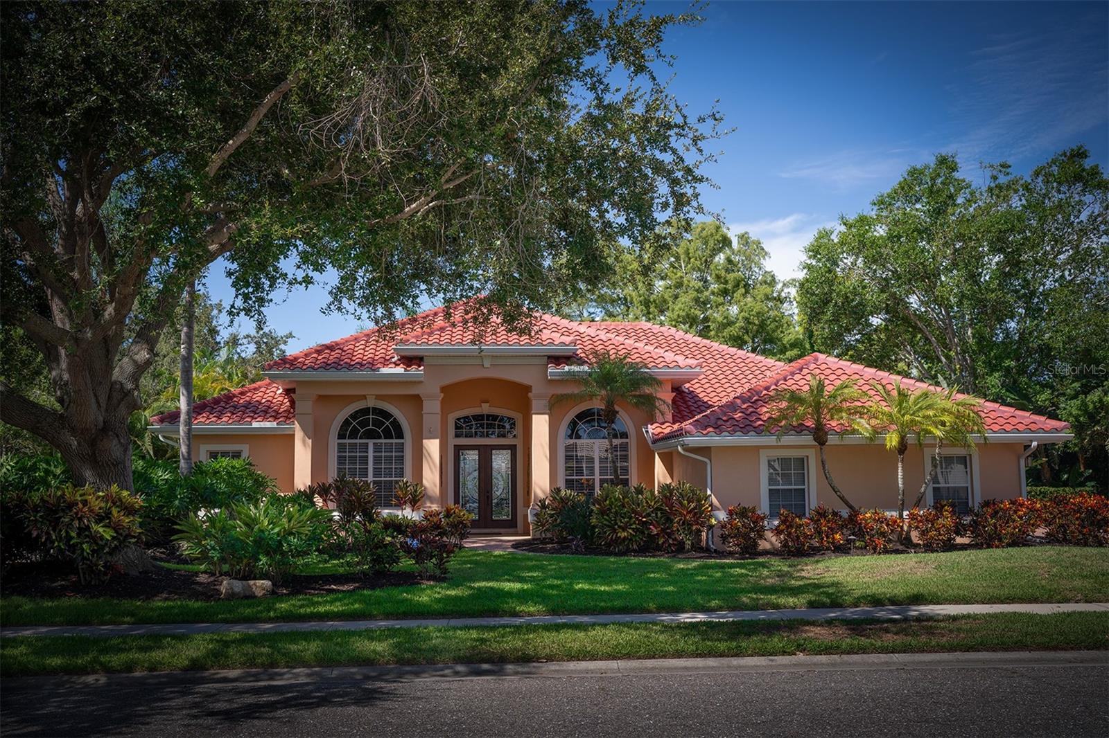 Welcome to an impeccably maintained, custom-built John Cannon home with sweeping lake and preserve views on a premium lot with plenty of privacy. This Allora II model with nearly 3200 SF, features an open split floor plan with soaring ceilings, oversized primary BR with crown molding, plantation shutters and sliding glass doors leading to lanai There are 3 full baths (1 with pool access), 3 additional BRs (all with walk-in closets) and a spacious office with custom-built cabinets and bookcases as well as a granite-topped desk/workspace. The side-entry 3 car garage offers work bench, custom storage, easy access to attic, along with paver brick driveway and walkways. Spacious lanai and pool area, with southwestern exposure, outdoor shower, paver brick deck and storage closet. The property offers beautiful outdoor landscape lighting and is wired for ADT security system. Spacious walk-in closets in all bedrooms. NEW ROOF AND SKYLIGHT 2023, dual-zone AC replaced in 2022, re-piped in 2006. The pool was resurfaced in 2017. A front entry double door with custom leaded glass inserts leads you to formal living and dining rooms. The large family room features a wood-burning fireplace and sliding glass doors that open to lanai. Family room opens to kitchen with SS appliances, quartz counters, wood cabinets, built-in wine rack, breakfast bar, and writing desk … all great for entertaining. The exterior of home was repainted and pool cage totally restored and re-screened in 2022. Interior custom ceiling lighting and track lights, all with low power LEDs added in 2017. Rivendell is an exceptional residential community, with close to 400 acres of lakes, ponds, preserves and lots of green space. The community offers social activities, park with playground and gazebo, and heated community pool. Close to Pine View School, a nationally recognized Sarasota public school for the gifted, grades 2-12. Tennis courts on school grounds are available to Rivendell residents when school not in session. Near Legacy Trail, beaches, shopping, medical facilities and much more!