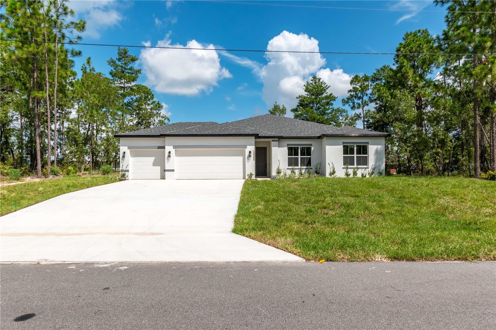 Ask about our Builder Incentives including interest rate buydown and closing cost assistance! Impeccably designed BRAND-NEW CONSTRUCTION 4-bed 3-bath-3-Car Garage home located in a great central Marion Oaks location close to everything Ocala has to offer! From the moment you arrive you will notice the difference with volume 9'4'' ceilings throughout the entire home. The main living space is centered around the Living Room with stunning 8' triple panel sliding glass door that overlooks the covered lanai which perfectly integrates the indoor/outdoor living space. The kitchen showcases Dolce White Quartz countertops, Samsung stainless steel appliance suite (3 Year Warranty), 42'' upper cabinets, entertaining island, and French doors with access to the cover lanai. Owner's Suite features trey ceiling, oversized dual sink vanity, tastefully designed shower with glass enclosure, and his & hers walk-in closets. All guest bedrooms are well sized with ample closet space. The private Guest Suite has an en-suite bathroom making it perfect for a Guest room or JR. Suite. Both Guest bathrooms feature tub/shower combo with floor to ceiling tile as well. Spacious Laundry room with an additional linen closet for added storage, plus the washer and dryer are included in the sale! Don’t miss your opportunity to make this house your HOME…Schedule your private tour today!