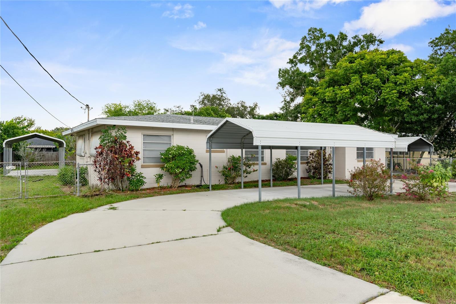 Welcome to 121 Coleman Road in Winter Haven—an updated 3 bedroom, 2 bath home that offers space, comfort, and flexibility at a great price. From the start, the circular driveway and three covered metal carports give you plenty of room for cars, boats, or weekend toys. Inside, you’ll find a light and open layout with two living rooms, a den, and a separate dining area—giving you plenty of room to relax, entertain, or even work from home. The home has been well cared for and features many recent updates including 2023 interior paint, vinyl plank flooring, updated lighting and ceiling fans, new doors, a 2023 A/C system with new ductwork, a 2020 water heater, and a 2016 architectural shingle roof. The kitchen has solid surface counters—both Corian and butcher block—stainless steel appliances, subway tile backsplash, and lots of cabinet space. The primary bedroom includes an updated private bathroom with a walk-in tiled shower, new fixtures, and a modern vanity. The two guest bedrooms are roomy and share a second updated bathroom with another walk-in tiled shower. Need more space? One of the living rooms can be turned into a 4th bedroom, game room, or home theater. Outside, a screened-in patio overlooks a large fenced backyard with a storage shed/workshop—perfect for hobbies, tools, or just enjoying the outdoors. Living in Winter Haven means you’re close to everything—lakes, parks, local shops, and a charming downtown with restaurants, festivals, and events. You’re also just 6 minutes from the Polk Parkway, making it easy to reach Lakeland, Tampa, or Orlando. With no HOA and a long list of upgrades, this home is a great find in a growing and well-loved Central Florida community.