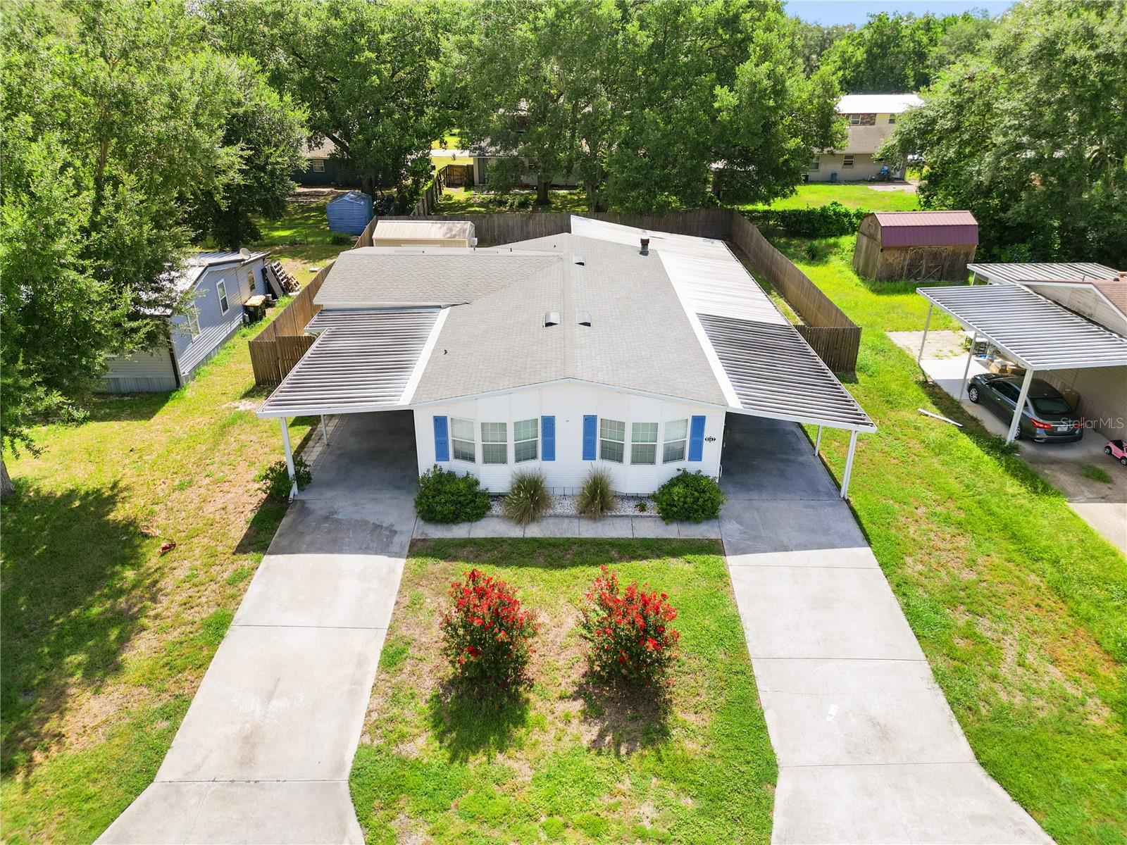 Welcome to 9147 Samaritan Avenue, a spacious and versatile home located in the quiet, no-HOA community of Mount Olive Heights in Polk City, Florida. This well-maintained double-wide manufactured home offers a rare and practical layout featuring a 3-bedroom, 2-bath main residence along with a fully equipped 1-bedroom, 1-bath in-law suite with its own private entrance—ideal for extended family, guests, or rental potential.
Inside the main home, you'll find an open-concept layout with a large living and dining area that flows into a thoughtfully updated kitchen. Renovated in 2010, the kitchen features ample cabinetry, extended counter space, a stylish glass backsplash, and updated appliances including a newer dishwasher, refrigerator, and stove. The primary suite is located at the back of the home for added privacy, while two additional bedrooms are situated at the front, creating a practical split-bedroom floor plan. A cozy wood-burning fireplace in the family room adds warmth and charm, and a dedicated laundry room provides convenience with newer washer and dryer units.
The attached in-law suite adds tremendous flexibility, offering its own living area, kitchenette, full bathroom with walk-in shower, and a private carport. Whether used for guests, older family members, or as a rental unit, this separate space is a major asset.
Outdoors, the property is just as impressive. Situated on a generous 0.2-acre lot, the home features two large covered carports, a screened-in porch, both covered and open patios, and a fully fenced yard—perfect for relaxing or entertaining. There’s also a powered workshop with a roll-up door and 240V connection, an electrified storage shed, and additional enclosed storage between the home and workshop.
If you’re looking for a move-in ready home with space, flexibility, and no HOA restrictions, 9147 Samaritan Ave offers a rare opportunity in a peaceful yet convenient setting. Schedule your private showing today!
