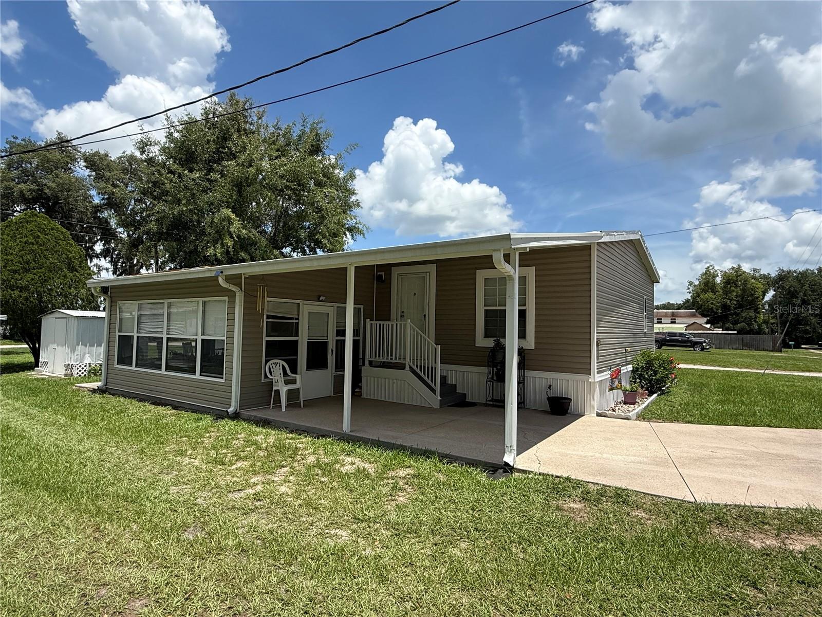 Immaculate to say the least. Come and see this meticulously maintained property. This Corner lot has a 2010, 2-bedroom 2-bathroom doublewide home situated on .13 acres, conveniently located in beautiful Zephyrhills Florida. This home will not disappoint. NO LOT RENT, NO HOA, NO CDDs. Upon entering you will immediately notice the care that has been taken to maintain the property and home. The roof is approximately 2 years old, and the A/C unit was just replaced in July of 2025. Laminate flooring throughout and a very stylish decor. Set back with a country feel but located near the main roads of Zephyrhills for quick access to dining, theater, bowling, hospital, shopping, churches and more. Great opportunity for the investor, winter home or your forever home with No HOA. Measurements are an estimate buyer/agent should verify. Schedule your exclusive tour today