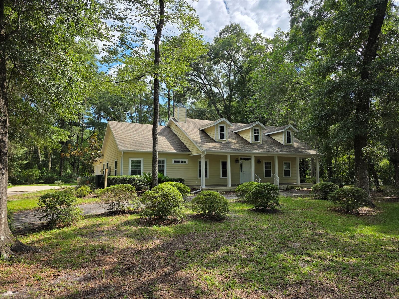 Welcome to your own private slice of old Florida paradise. Located at the end of a quiet, dead-end street in the NW area of Williston, this 3/2 cottage offers the perfect mix of traditional charm, privacy, and convenience. Surrounded by beautiful woods and thoughtfully set back from view, this home is ideal for anyone looking to unwind in a quiet, natural setting, with a little bit of land—while still enjoying proximity to modern amenities and some of the best outdoor activities in the Nature Coast section of Florida. The circular driveway, with plenty of parking for guests, brings you right up to the door step of the front porch. From this vantage point, you already know your new daily routine; extra tasty morning coffee and late afternoon reading…served up with a side of tweeting birds and quiet! The spacious 2-car garage, offers plenty of space not just for vehicles, but the huge extra storage room is really the bonus here…it could easily be a workshop, small in-home gym, or just more space for all the stuff you own! Animal lovers will appreciate the fenced-in dog yard, attached to the oversized screened-in back porch right off the kitchen, so your fur babies can come and go easily from the house. And while you’ll enjoy the seclusion of being tucked away in the woods, you’ll still have neighbors nearby—just not within your direct line of sight. Nice blend of seclusion and security! The scenic backroads through Archer offer an easy and enjoyable commute to Gainesville, making this an excellent option for professionals, students, or healthcare workers looking to get away from the city without being too far removed. Located in Levy County, this property benefits from low property taxes and is within easy access to countless north Florida treasures. Outdoor enthusiasts will be in heaven—this cottage is within 30 to 40 minutes of the Gulf of Mexico, Cedar Key, the Suwannee River, the Rainbow River, and numerous crystal-clear freshwater springs. Whether you love kayaking, fishing, boating, hiking, or simply floating the day away, you’ll find endless opportunities to enjoy nature in every direction. And then there’s Williston itself—a tight-knit small town with a strong sense of community. From Friday night high school football games and seasonal local festivals to active churches, civic organizations, and friendly neighbors, this town is the kind of place where people still know each other by name and stop to say hello. Whether you’re looking for a full-time residence, a weekend retreat, or a quiet place to slow down and reconnect with nature, this unique property offers a rare opportunity to live the North Florida lifestyle so many dream of. Not much in the current active listings that compare to this home and location on two acres….this one won’t last long!