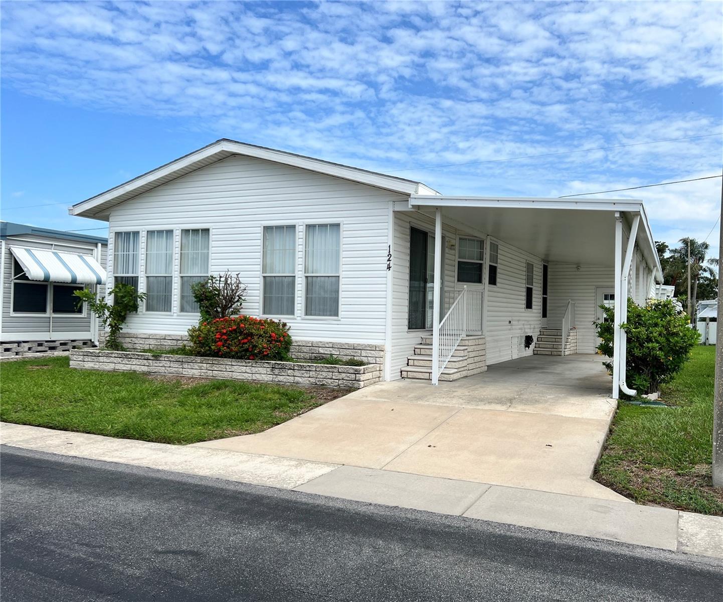 Don’t miss the opportunity to live in the highly sought after, resident-owned, Lake Highlander Mobile Home Park in Dunedin. This well-maintained 2003, fully furnished 1270 sq ft double wide has 2 Bedrooms and 1 1/2 baths with bonus Florida room and is ready for you to move in, just bring your tooth brush! The kitchen comes with stainless steel appliances including refrigerator, stove, dishwasher and microwave. The master bedroom is large with extra closet space. Master bath has a walk-in shower. Vertical blinds throughout the home. Washer and dryer are inside in a laundry room with a deep laundry sink. Carport is large enough for 2 vehicles.
Friendly 55+ community offers a geothermal heated pool, clubhouse with billiard and game room, spacious lanai, shuffleboard, laundry facility (home has private washer/dryer included) and a beautiful lake. LOW monthly HOA fee of $255 and includes water, sewer, trash, lawn-care, and all park amenities. Pet Policy: 2 indoor cats only, no dogs (unless service or ESA).
Lake Highlander is a golf-cart community and close to downtown Dunedin which offers plenty of shops and restaurants as well as walking and bike riding options on the popular Pinellas Trail. Call today to schedule your showing at this prime location!