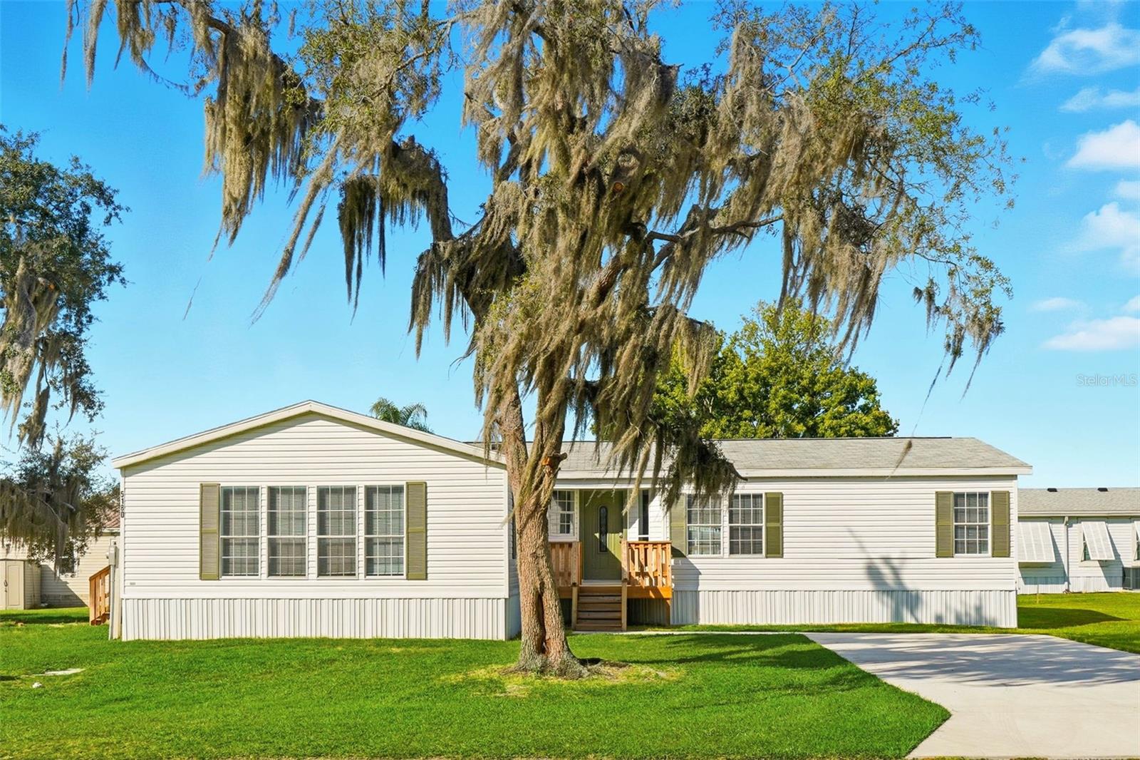 WELCOME TO 5180 LEXINGTON CIRCLE- YOUR FUTURE HOME! BEAUTIFULLY RENOVATED FROM TOP TO BOTTOM! THIS 3 BEDROOM, 2 BATH TRIPLE WIDE MANUFACTURE HOME, OFFERING A PERFECT BLEND OF MODERN STYLE AND COMFORT. WITH A SPLIT PRIMARY BEDROOM FLOOR PLAN, YOU'LL ENJOY PRIVACY AND FUNCTIONALITY FOR EVERYDAY LIVING. STEP INSIDE TO FIND A BRIGHT AND AIRY LAYOUT FEATURING A GREAT ROOM AND A LIVINGROOM WITH OVERSIZED WINDOWS THAT FLOOD THE HOME WITH NATURAL LIGHT. THE VAULTED CEILINGS AND CONTEMPORARY FINISHES CREATE AN OPEN, INVITING ATMOSPHERE THROUGHOUT. AT THE HEART OF THE HOME, THE LARGE KITCHEN BOASTS PREMIUM SOLID WOOD CUSTOM CABINETS, GRANITE COUNTERTOPS, AND PLENTY OF STORAGE, MAKING IT AS PRACTICAL AS IT IS STYLISH. THE PRIMARY SUITE IS A TRUE RETREAT, COMPLETE WITH A JETTED SOAKING TUB FOR ULTIMATE RELAXATION. THE ADDITIONAL GUEST BEDROOMS ARE GENEROUSLY SIZED AND VERSATILE FOR GUESTS, HOME OFFICE, OR HOBBIES. OUTSIDE, THIS HOME SITS ON A LOT AND A HALF, GIVING YOU EXTRA SPACE FOR OUTDOOR LIVING, GARDENING, OR SIMPLY ENJOYING THE FLORIDA SUNSHINE. LOCATED JUST OUTSIDE OF THE VILLAGES AND STEPS FROM BROWNWOOD PADDOK SQUARE, YOU'LL HAVE SHOPPING, DINING, AND ENTERTAINMENT RIGHT AT YOUR FINGERTIPS WHILE STILL ENJOYING A PEACEFUL NEIGHBORHOOD SETTING.