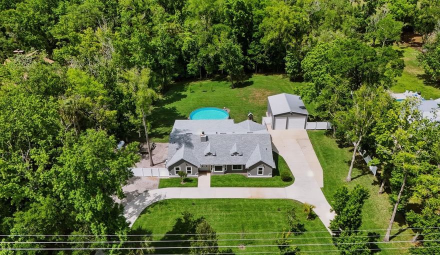 Don’t miss the opportunity to see this exceptional property! Located in the desirable Ranchlands neighborhood of Winter Springs, this exceptional property sits on over 1.5 acres of land, offering both space and privacy. A large circular driveway provides easy access and ample parking.  This well-maintained home features 4 bedrooms, 2 bathrooms, and over 2,100 square feet of living space, with a split floor plan ideal for both everyday living and entertaining. As you enter, you’re welcomed by a bright, open interior showcasing tile flooring throughout the home, high ceilings, and an abundance of natural light.  The upgraded kitchen is a standout, featuring stainless steel appliances, granite countertops, plenty of cabinet storage and a kitchen nook. The spacious family room includes a cozy fireplace, along with a mounted TV and surround sound system that will convey with the home.  The primary suite offers private access to the backyard through sliding glass doors, a walk-in closet, and a generously sized en-suite bathroom complete with dual sinks, and a tub/shower combo.  Step outside to enjoy the expansive covered lanai—perfect for relaxing or entertaining—along with a 30' above-ground pool to enjoy Florida’s warm weather and a play area for the little ones.  Additional upgrades include a home generator, AC and septic tank and pump all installed in 2017, a water heater in 2018, pool in 2020, roof in 2021 and pool pump in 2026.  In addition to the attached 2-car garage, the property also features a 25' x 30' detached garage equipped with electricity and AC—ideal for extra vehicles, a workshop, or storage. A side-entry gate provides access for RV or boat parking to store in your backyard. With no HOA, you’ll enjoy the flexibility to use the property as a primary residence, investment, or income-producing opportunity.  This hidden gem offers a peaceful, country-style setting while still being conveniently located near major roads, shopping, and dining. Come see it today and make it yours!