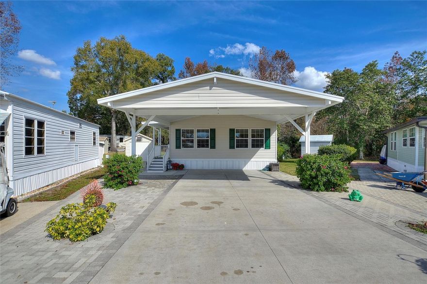 Model perfect!! "Move in ready" spacious newer "FURNISHED" doublewide manufactured home located on a larger lot backing onto to a wooded area for privacy located in the 55+ Citrus Ridge community in the heart of Davenport.  This beautiful home offers lots of room, open floor plan, large bedrooms, coffered and cathedral ceilings, Luxury vinyl planking on the floors. The EXTERIOR of this home offers a paver 26' carport for 2 vehicles, covered paver side patio, double pane windows, French doors, and gutters. There is a detached  wood workshop with equipment that is included in the sale.  All of this and this home backs on to woodlands for privacy and on a larger lot. Citrus Ridge community has very low HOA dues, no CDD, amenities such as a clubhouse complete with an entertainment facility, activity center, full kitchen, recreational room, community swimming pool, shuffle board and pickle ball courts , and a library. Citrus Ridge is located just off hwy # 27 1.5 miles South of I-4 and very near the Posner 1.5 million sq.ft open air mall. Advent hospital and medical facilities, restaurants, and grocery stores are located very nearby. There is a Publix under construction as well as a new Sam's Club and Walmart about 1 mile from this location.