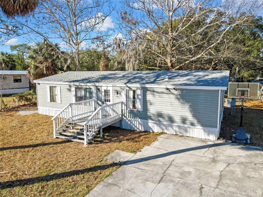 Freedom, space, and opportunity come together on this rare half-acre property in the heart of Hudson. This 3-bedroom, 2-bath totally renovated manufactured home offering 1,200 sq ft of living space and sits on a 0.51-acre lot, providing the kind of land and flexibility that’s increasingly harder to find with no HOA restrictions. 
UPGRADES 2022: New Roof, New A/C System and Ducts, Floors, Electrical, Plumbing, Kitchen and Baths all NEW 2022! Water Heater 2019! The home is post-1977 construction, set on a crawlspace foundation.
Inside, the open floor plan features durable laminate flooring in the kitchen and main living areas creating a functional flow for everyday living. The kitchen offers Granite countertops, ample cabinetry, and flows directly into the family room, ideal for entertaining or relaxed gatherings. A wood-burning fireplace adds warmth and character to the living space. 
The split-bedroom layout provides privacy, with the primary bedroom featuring a walk-in closet and en-suite bath, while two additional bedrooms are perfect for guests, family, or a home office. An additional bathroom and indoor laundry add everyday convenience.
Outside, the fenced expansive yard invites you to bring your toys, pets, and vision — with plenty of room for a boat, RV, workshop, garden, or future expansion. A deck and concrete driveway add to the property’s functionality and privacy.
Location is a major plus, with quick access to US-19 for an easy commute north or south, and just minutes from shopping, grocery stores, restaurants, and everyday conveniences. Medical facilities and hospitals are close by, and Hudson Beach, parks, fishing, and waterfront dining are only a short drive away, giving you the best of relaxed Florida living with modern convenience.
Whether you’re looking for a primary residence, winter retreat, or investment opportunity, this property delivers space, updates, and value in a convenient Florida location. Schedule your private showing today!