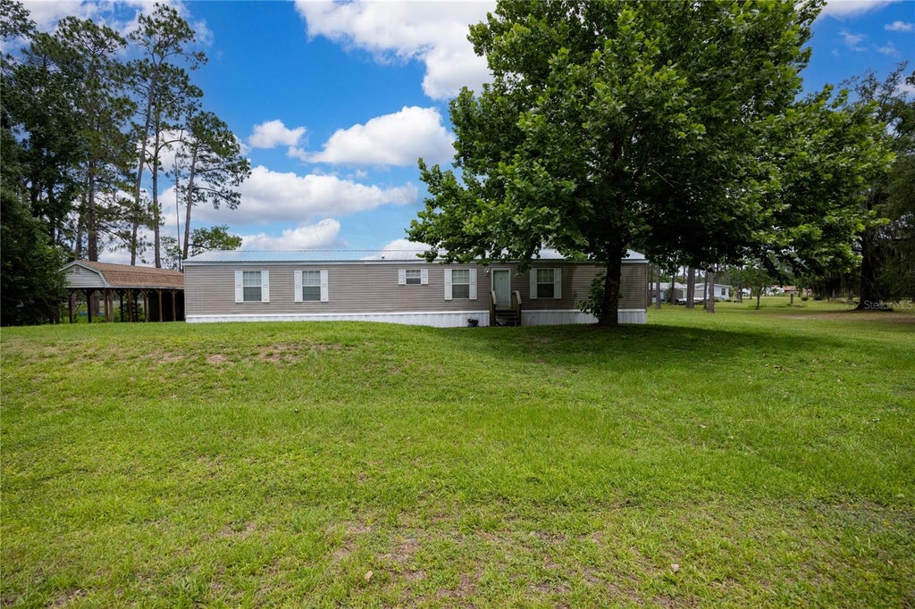 Photo of 116 Tyler Avenue, Interlachen, FL 32148 (MLS # GC541028)