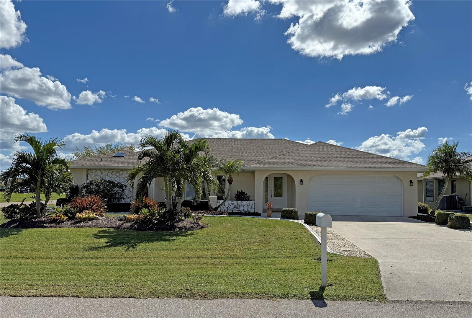 Impressive 3 Bedroom, 2 Bathroom home with attached 2 Car Garage located in the desirable deed restricted community of DEEP CREEK. NOT in a flood zone. This light and bright home features an open and split bedroom floor plan with Living Room, Dining Room, Family Room, well appointed Kitchen, Inside Laundry and large screened lanai. The Living Room offers large windows, tile floor and cathedral ceiling. The separate Dining Room has French doors to the Lanai. The Kitchen features white cabinetry, granite counters, tile backsplash, double sink, pass thru to the lanai, double sink and dining area. Appliances include refrigerator, oven/range, dishwasher, microwave. The Inside Laundry offers a front loading washer, front loading dryer, cabinets and laundry sink. The Master Bedroom suite offers French doors to the lanai, two walk in closets and private bathroom with double sinks, walk in shower and bathtub. There are two additional guest bedrooms with walk in closets and a guest bathroom with a tub/shower combination. Your living space extends to the large screened lanai with greenbelt view. Other features include: tile floors in the living areas, rain gutters, cathedral ceilings in Family Room and Living Room, skylight in master bathroom, IMPACT GLASS, arched doorway, NEW A/C 2024.....NEW HOT WATER HEATER 2023......NEW ROOF 2023.....PLUMBING REPIPED 8 YEARS AGO. This home is located minutes from shopping, dining, entertainment, I-75 and short drive to waterfront parks and boat ramps. Easy drive to gorgeous Golf beaches in Englewood and world class fishing on Boca Grande.