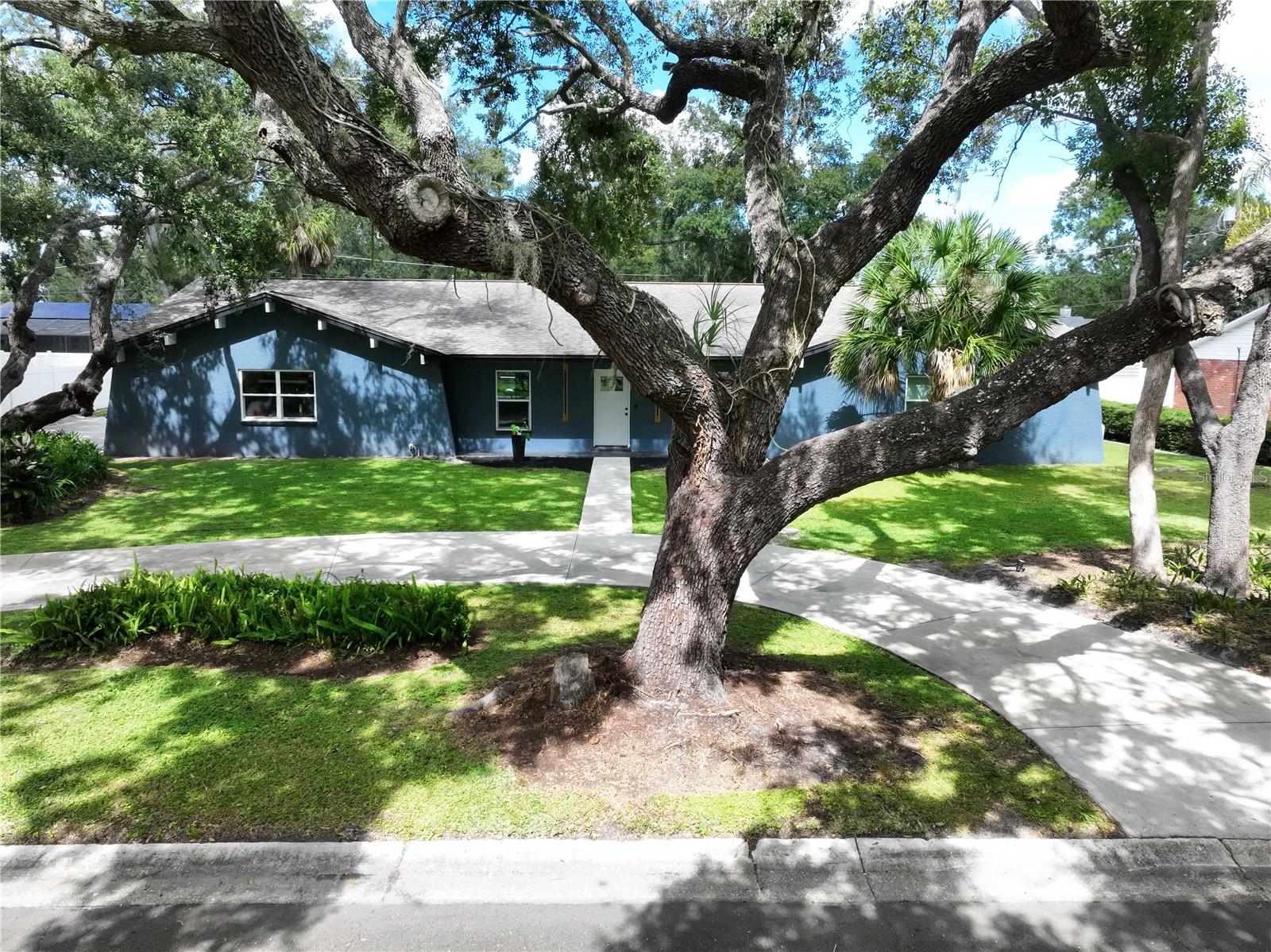 Out of town buyer changed their mind. Their loss your opportunity! Welcome to 1404 Big Oak Court in Brandon, Florida! This modern mid-century home has everything you need to enjoy the Florida lifestyle. Drive up to a circular driveway and step into the foyer, which boasts higher-than-average ceilings for this style of home. One side of the foyer leads to a space that can be used as a formal dining room or bonus room, while the other side, through French doors, opens to a den or additional bonus area. The foyer flows into an open floor plan featuring a modern kitchen with an oversized granite island, stainless steel upgraded appliances, modern light fixtures, ample cabinet space, and plenty of natural light, and has Reverse Osmosis water treatment. The kitchen overlooks the spacious great room, complete with a stone fireplace, updated sliding glass doors, and windows. 
The bedrooms are located on the opposite side of the house, with the primary suite in its own private wing. The primary bedroom offers a walk-in closet, a walk-in shower, a double vanity, and a separate shower and toilet area equipped with a bidet. There are three additional bedrooms and a second full bathroom with a shower and tub. This home has been fully remodeled, including a new HVAC system, updated electrical panel, updated plumbing, resurfaced pool interior, new pool pump, and pavers around the pool deck.  Live the Florida lifestyle in your outdoor living space on your well-designed lanai with that beachy vibe.  This outdoor space has plenty of room for pool parties. The property is surrounded by mature landscaping, providing shade and charm, and features a circular driveway, an extra parking pad, and a two-car garage. Every corner of this home has been cared for with love!
And the location couldn’t be better—just minutes from shopping, restaurants, the airport, and beaches. This dream home is ready and waiting for you!