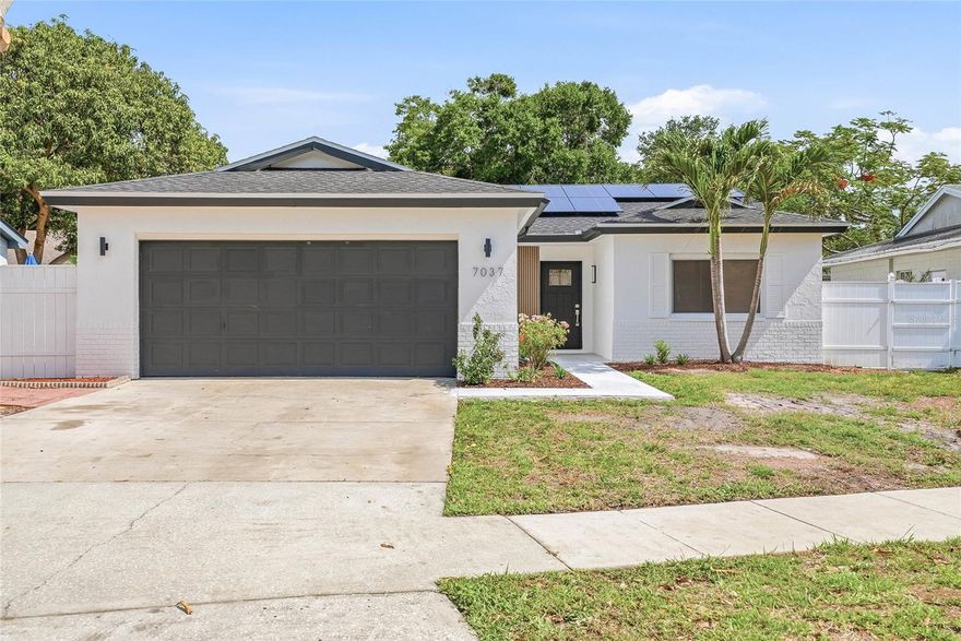 Welcome to this beautifully updated 4-bedroom, 2-bathroom block POOL home in the heart of Pinellas County, where comfort, style, and convenience come together effortlessly. From the moment you arrive, you’ll appreciate the added features like exterior lighting, rain gutters, and a spacious 2-car garage, plus the bonus of fully paid-off solar for energy efficiency and long-term savings. Inside, luxury vinyl plank flooring flows seamlessly throughout the home, creating a clean and cohesive feel. The updated kitchen is the true heart of the home, featuring quartz countertops, a center island, and new appliances, perfect for both everyday living and entertaining. The layout offers two separate living spaces on either side of the kitchen, allowing for flexibility as a living room and dining area, with one space opening directly to the pool and patio for effortless indoor-outdoor living. The primary suite offers a private retreat, complete with an updated en suite bathroom and direct access to the pool, ideal for those quiet morning coffees or evening unwinds. Both bathrooms have been thoughtfully updated, and all four bedrooms provide comfortable, flexible living space. Major updates offer peace of mind, including a newly replaced AC, updated windows, and a roof replaced in 2023, enhancing both comfort and efficiency. Step outside to your own backyard oasis, featuring a sparkling pool, fully fenced yard, and plenty of room to relax or host. The covered patio adds shade and functionality, making it the perfect extension of your living space year-round. Tucked into a quiet neighborhood with easy access to both downtown St. Petersburg and the Gulf beaches, this home offers the best of Florida living in a prime central location.