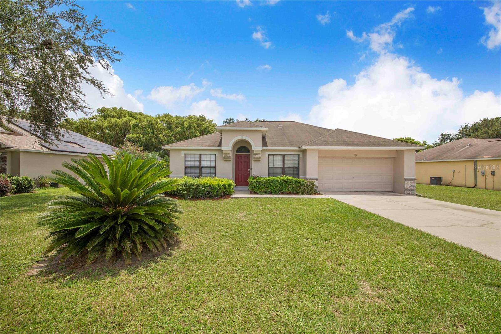 Welcome home to this charming and bright 3 bedroom, 2 bath move in ready home in the lovely Oak Crossing subdivision in Winter Haven, FL. You'll notice the lush, mature landscaping and veneer stone accents before entering a well thought out open floor plan. The kitchen offers granite counters, stainless appliances and plenty of room for a dinette or even and office desk or bench seating. It's a blank canvas with gorgeous wood-look tile flooring throughout the kitchen and living room! Your primary bedroom en-suite offers a walk shower, no tub to step over in here! The serene backyard may be left as is as it's quite private already, or could easily be fenced in for additional privacy. Newer HVAC in 2022! Call today before this beautiful home in a well-established neighborhood is scooped up!