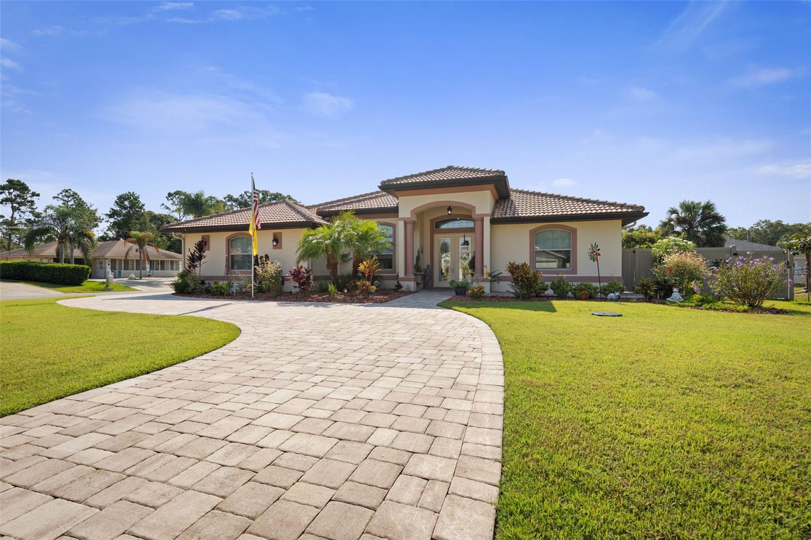 This stunning home offers luxurious living in the highly sought-after "F " section of Palm Coast. Meticulously maintained home spans over 2,500sqft of thoughtfully designed living space with high-end finishes and many upgrades. Skip the wait of construction when this amazing home is ready and fully equipped with upgrades to elevate your comfort and lifestyle. Nestled on a corner lot, the home's beautiful curb appeal, manicured landscaping, paver driveway and walkways and elegant entryway with double doors invite you to step inside to discover timeless elegance and functionality in this well appointed 3 Bedroom 3 bath 2 car garage home. Inside the grand foyer discover a beautiful spacious open concept layout with refined architectural details, soaring 12ft double tray ceilings, crown moldings and ceramic tile throughout main living area. The heart of the home is a showstopper chef's inspired gourmet kitchen with upgraded wood cabinets, stainless steel appliances, a gas range, a wall oven-microwave combo, a corner pantry, an amazingly inviting granite kitchen island ideal for both casual dining and entertaining. It flows seamlessly into the formal dining area or kitchen nook with direct access through French doors to the covered and screened porch complete with a full summer kitchen that creates an effortless connection between indoor and outdoor living. Conveniently located off the kitchen nook is a dedicated study/office space. Tucked away, unwind in the luxurious primary suite, a private sanctuary boasting engineered wood floors, dual walk-in -closets, and an ensuite spa-like bathroom adorned with exquisite tile, dual vanities, a soaking whirpool tub, a large walk-in tiled shower and a private water closet. The split floor plan provides a peaceful retreat for family and friends. The two additional bedrooms are generously sized with engineered wood floors, double tray ceiling , one of which also has an ensuite bathroom complete with tiled walk-in shower. An incredible in house spacious laundry room with plenty of cabinets and counter space. The 2 car garage tiled floors adds a sleek, durable finish, remote control screened doors and a side service door onto paved walkways that lead around entire home, all enhance functionality. Additional amenities: never loose power with the WHOLE HOUSE GENERAC generator; owned propane tank feeds generator, both gas stove's and barbecue grill; central vacuum, fully fenced yard; sprinkle system on well, rain gutters and much more . Schedule a private tour and see why this exceptional home is the perfect blend of luxury, functionality and ultimate comfort!