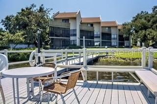 This charming updated ground floor condo features 2 bedrooms and 1 bathroom and is the lowest priced unit in the Bay Oaks complex. The unit comes completely furnished, allows short term rentals and has a proven excellent cash flow. The condo is equipped with a full kitchen and reserved covered parking, a water view from the lanai and is located in beautiful Siesta Key, Florida. This particular unit is located about 30 feet from the intracoastal waterway, so soak up pristine gulf views right from your own lanai! It is also a stone's throw away from the community's heated pool. As a condo unit, it provides a cozy and comfortable living space where you can live every day as if you are on vacation. This is the perfect opportunity for a low-maintenance lifestyle, making it ideal for those seeking a permanent residence, vacation home, a rental property, or a peaceful retreat. Check out the virtual tour then book your showing today. The refreshingly updated and clean interior is sold in turnkey condition with all furnishings. Everything in the condo is included in the sale, including the beds, couch, furniture, televisions, and all appliances. Includes updated bathroom, kitchen, insulation in ceiling for efficiency and sound dampening, and tile on the lanai. This condo unit also has a very strong rental history, boosted by the water view from the lanai, easy ground floor location, and the nearby proximity to the pool. Amenities include a water view from the lanai, heated pool, tennis court, dock on the bay, fishing pier, community barbecue grill, community billiard room, 1 parking space (and access to additional visitor space), washer and dryer in unit, outdoor closet for additional storage, and the convenience of low maintenance condo living. All common area and outdoor maintenance is the responsibility of the condo association. The association also pays for internet, water, and trash. The exterior of the property boasts a well-kept and manicured landscape, enhancing the overall appeal of the condominium. The surrounding area is lush and green, creating a tranquil environment to enjoy. This property is nearby to the world-renowned Siesta Key beach area with its powdery white sands and crystal-clear waters. It is also on the Siesta Key trolley line with a stop right out front, and it is near to vibrant Sarasota nightlife and dining options. There is always something to explore and enjoy in this coastal paradise.