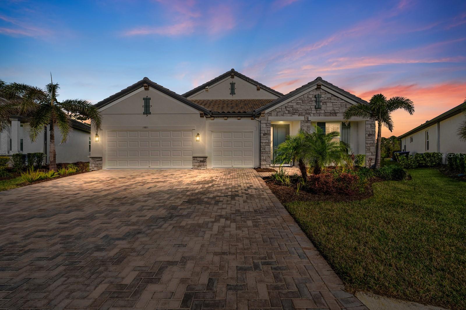 This immaculate 2022 built Crystal Model, Elevation B, by M/I Homes is a stunning showcase of Tuscan/Mediterranean architecture, complete with a classic tile roof and exceptional attention to detail. Designed for both beauty and function, the home features a thoughtful, high quality layout and luxury upgrades throughout. It is situated in a non flood zone and has never sustained storm damage, offering peace of mind.
Set off the neighborhood road, tucked behind an island of mature palm trees, this phenomenal private lot offers a rare sense of seclusion. With no rear neighbors, it is quietly nestled within the gorgeous Wellen Park neighborhood of Oasis, off the beaten path yet close to it all.
The residence includes four generously sized bedrooms, three full bathrooms, and a spacious three car garage complemented by an oversized three lane driveway. Throughout the interior, upgraded tile flooring extends seamlessly from room to room with no carpeting and no thresholds, enhancing the clean, modern aesthetic.
The gourmet kitchen is a chef’s dream, boasting elegant white cabinetry, quartz countertops, and a sprawling 7.5 foot island with abundant storage. Custom features include built in pantry space, dedicated pots and pans drawers, and a hidden trash cabinet. A stylish white wood range hood adds a sophisticated focal point. Additional upgrades include a reverse osmosis system and a whole home water softener for added comfort and quality.
Crown molding and recessed lighting elevate the open concept kitchen and great room, creating a light, airy atmosphere perfect for everyday living or entertaining. Expansive sliding glass doors line the back wall, opening to an extended lanai and a beautifully paved 29 by 22 patio, ideal for outdoor gatherings or future pool installation. The 11,522 square foot lot offers ample space and privacy, surrounded by lush palms.
Located in the finished, gated, and maintenance free community of Oasis, comprised of approximately 140 single family homes, residents enjoy access to premium amenities including a resort style pool, clubhouse, and pickleball court. Oasis also features a private walking trail connecting to the adjacent gated neighborhood and directly to Blue Heron Dog Park, a 33 acre green space offering two miles of trails and two separate off leash dog parks.
Wellen Park is a vibrant, master planned community offering a lifestyle centered around connection, wellness, and recreation. Residents can enjoy shopping, dining, and entertainment at the Wellen Park Town Center, or take in a game at CoolToday Park, the spring training home of the Atlanta Braves. The community also features a splash pad, outdoor concerts, a weekly farmers market, and miles of walking and biking trails winding through beautifully landscaped parks and green spaces.
Oasis is ideally located within Wellen Park, just 10 miles from the Gulf Coast’s stunning beaches and conveniently situated across from Costco, Publix, Chase Bank, medical offices, and the State College of Florida’s Venice campus.
This home is packed with practical extras, including appliance manuals, a water softener, reverse osmosis system, and surplus materials such as floor tile, backsplash tile, trim, roof tiles, and paint. Additional features include smart garage and doorbell systems, as well as a built in Taexx pest control system for added convenience.