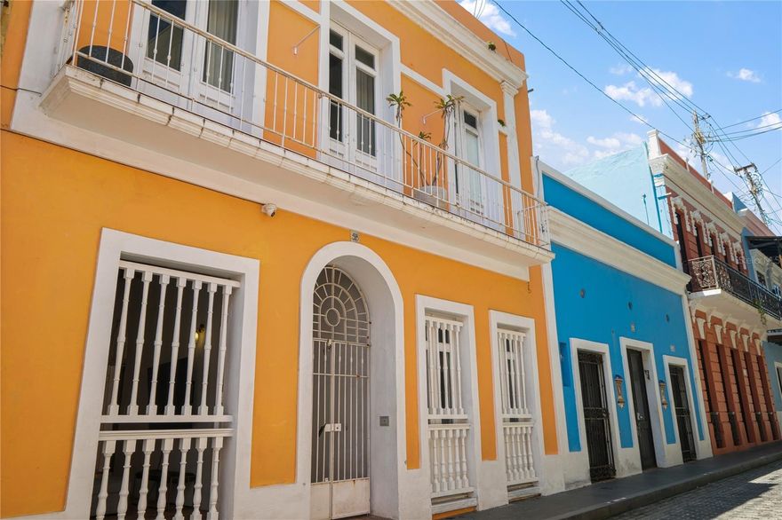 Fall in love with the timeless charm and captivating essence of Old San Juan in this stunning Spanish colonial gem, where historic elegance meets modern opportunity. This beautifully preserved property, certified tax-exempt by the Instituto de Cultura Puertorriqueña (ICP), offers three fully independent units: a cozy 1-bedroom, 1-bath unit, a spacious 2-bedroom, 1-bath unit, and a stunning 2-bedroom, 2-bath penthouse with private terraces and a balcony overlooking the colorful streets. With soaring ceilings, exposed wooden beams, arched windows, and intricate ironwork, every detail celebrates the building’s rich architectural heritage. A lush interior patio creates a peaceful retreat in the heart of the city, while a shared laundry room adds convenience. Currently generating around a 10% CAP rate through short-term rentals, this property is ideal for those seeking a romantic personal haven, a smart income-producing asset, or both—all set within one of the Caribbean’s most enchanting historic districts.