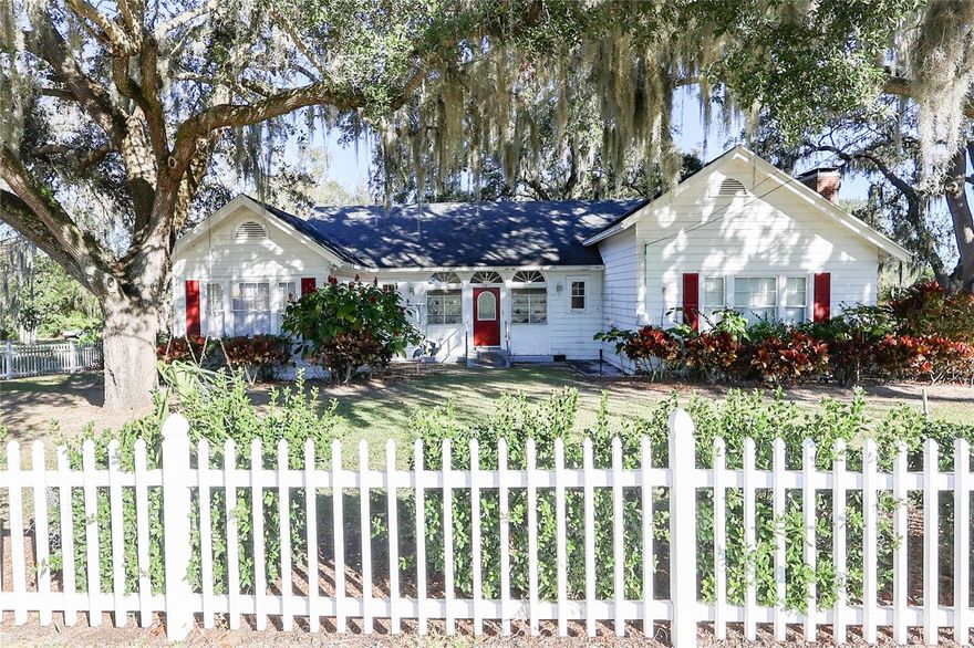 Historic Southern Charm on Lake Eva – Nearly 1 Acre in Haines City, FL

Discover timeless Southern charm in this 3-bedroom, 1-bathroom single-family home situated on nearly one acre of land with 25 feet of direct lake frontage on Lake Eva. Shaded by mature oak trees and enclosed by a classic white picket fence, this property offers rare character, space, and waterfront access.

The home retains its historic appeal while providing comfortable living space ideal for those who appreciate traditional architecture and a relaxed lakeside lifestyle. Enjoy tranquil views, open green space, and the privacy that comes with a generously sized lot—perfect for outdoor entertaining, gardening, or future possibilities.

A detached two-car garage with workshop adds exceptional functionality, offering ample room for storage, hobbies, or projects.

Located in Haines City, Florida, this unique lakefront property combines charm, land, and location—an excellent opportunity for homeowners, investors, or those seeking a one-of-a-kind residence.