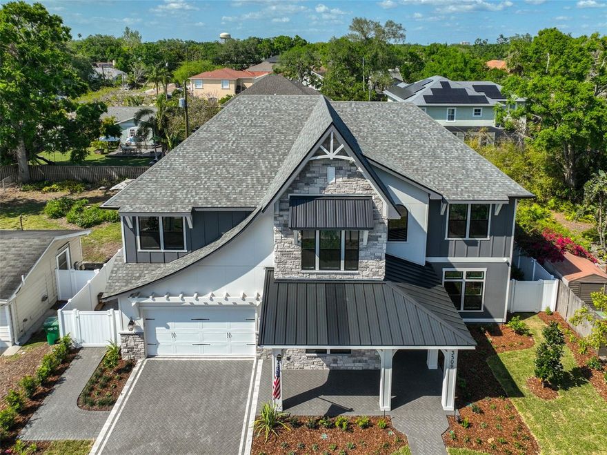 MOVE IN READY! Experience a remarkable lifestyle when you reside in this stunning new construction South Tampa pool home. Situated in the highly sought-after Roosevelt, Coleman, and Plant school district, this exclusive Reflection Custom Home property has 4,690 SF of interior living space featuring 5 bedrooms, 5 1/2 bathrooms, media room, study & a 3 car tandem garage on a 80 x 120 lot NOT in a flood zone. A luxury landscape package, dramatic sloped roof lines, and artful touches invite you to explore the comfort and luxury that await inside. The 2 story foyer leads through to entertaining-sized living rooms with views of the pool. The gourmet kitchen showcases modern style and comfort, with upscale Fisher & Paykel appliances, island seating, custom cabinetry, pantry prep room, pass through window to outside lanai, and an open flow to the family room with a gas fireplace. The flexible 1st-floor layout features a study w/decorative antique wooden doors, guest suite with private bath, mudroom, and pool bath with space for a stackable washer/dryer complete the main level. The second level includes a lux primary suite with sound insulated walls, a spacious bathroom w/soaking tub, and a large custom closet plus the remaining 3 bedrooms, each w/custom baths & generous closets, a media room and a 2nd floor laundry room with dog wash station. The amazing rear property overlooking the pool and spa has a covered lanai with stained wood tongue & groove ceiling and a summer kitchen with 618SF of covered outdoor living space. Additional upgrades include: Elevator, whole home generator, impact windows, in-wall pest tubes, Elan Smart Home System, smooth drywall, interior 8ft doors, crown molding, 25 Seer HVAC w/multi zoned control, Icynene R-21 spray foam insulation, speaker pre-wires, LED exterior holiday lighting, 2-10 Builder Warranty & so much more.
