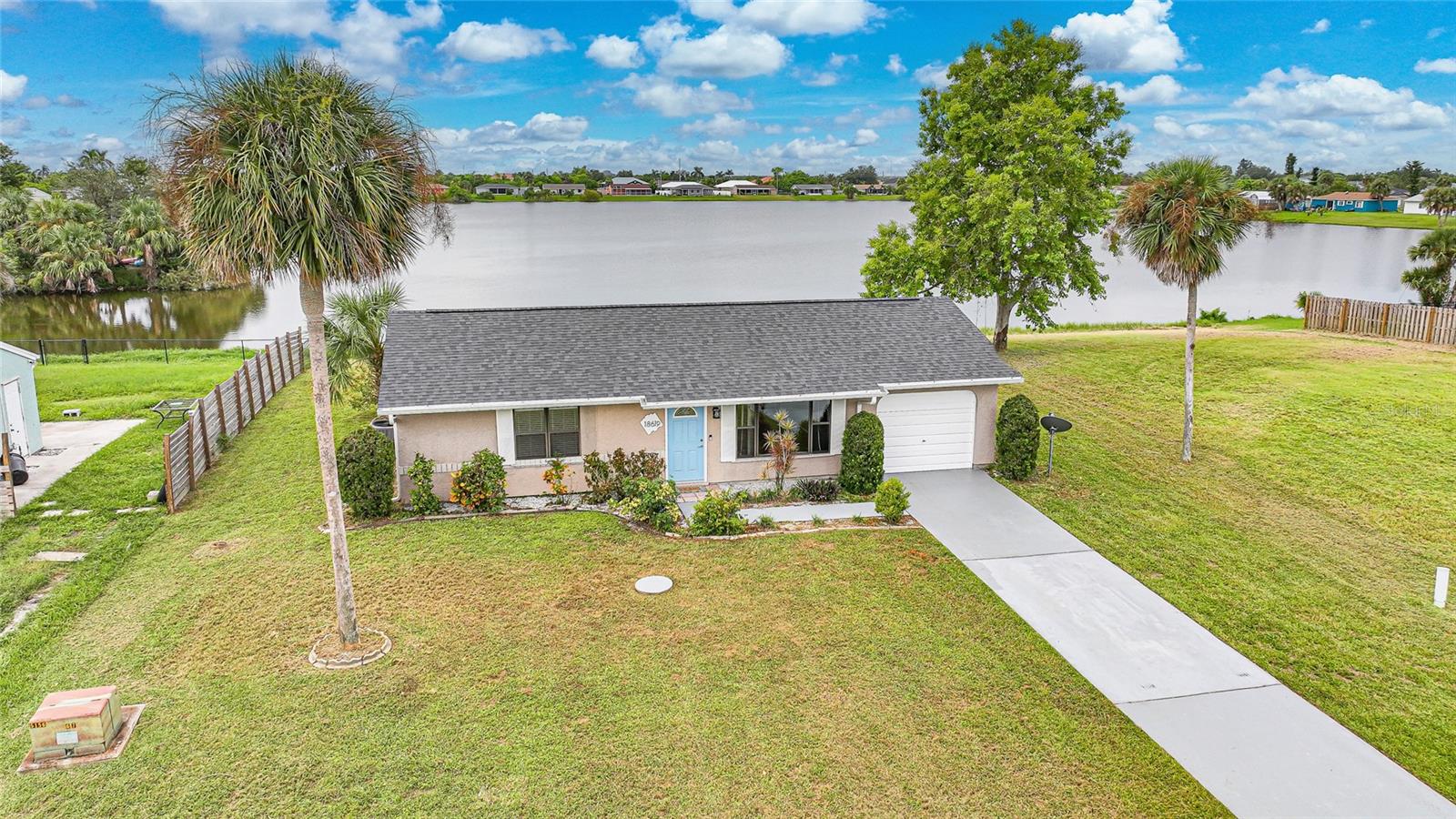 Look at this neat and immaculate 2 bedroom lake front home located in a quiet neighborhood in the center of Port Charlotte. Beautiful setting with expansive view of the 17 acre lake from your screened lanai or patio. Kitchen is updated with warm wood cabinetry, smooth counters, and new appliances. The spacious living room lake views and is excellent for entertaining. Primary suite has private access to the updated bath, new flooring, walk in closet, and crown molding. 2nd bedroom also has new flooring and a walk-in closet for extra storage. You will be living in style on your brick paved lanai and patio overlooking the beautiful lake. Underground electric from the pole to home. Public water and sewer. New roof, ductwork and insulation. Looking for the perfect winter getaway? This is it! First time home buyers looking for your perfect home? This is it! Why rent when you can own for less? Conveniently located near shopping, restaurants, hospitals, and a short drive to Gulf Beaches. “Virtual Tour 1” to view the 3-D Tour and Floor Plan. "Video Tour 2" to view video tour.