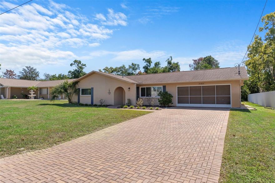 Welcome to this updated 2-bedroom, 2-bath home HOME OWNER IS CURRENTLY ADDING A NEW ROOF! this home is Situated on a 0.30-acre corner lot, this home boasts an open-concept layout connecting the kitchen, dining, and living areas for a functional and inviting main living space. Just off the main living area, an enclosed Florida lanai offers a quiet space to unwind. Step outside to a beautifully landscaped backyard with privacy fencing on two sides, providing ample room to garden, play, or create your dream outdoor oasis. Enjoy added peace and quiet with private land behind the home, offering no rear neighbors. Additional features include a two-car garage with attic storage, a four-year-old HVAC system, and the advantage of being located in a no-flood zone. The new roof will be on by the end of April!