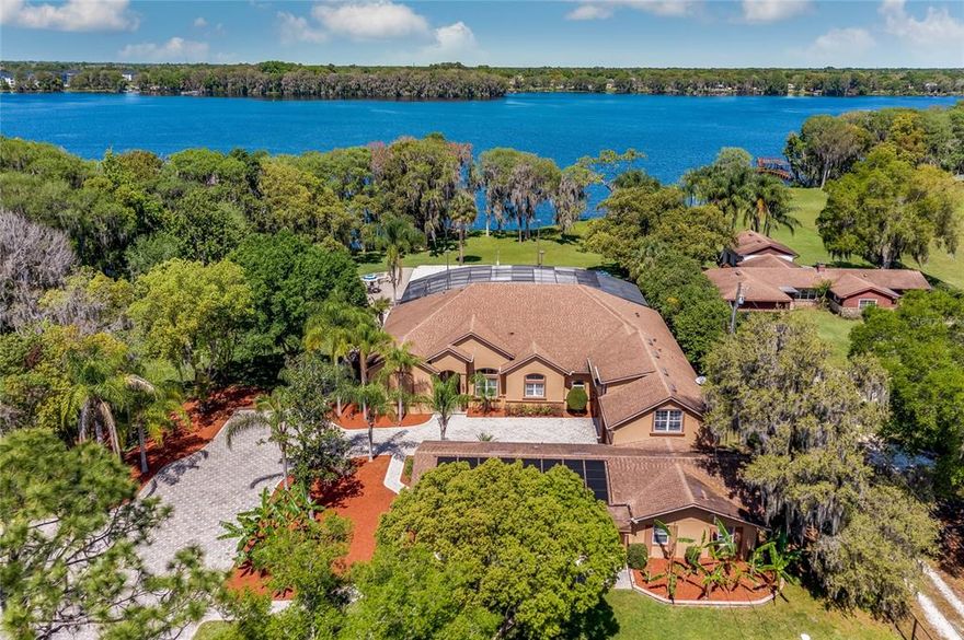 ONE-OF-A-KIND, 8-Acre, LAKEFRONT, Paradise on Lake Howell (a private, skiable lake) in Winter Park.  Over 220 FT. of LAKE FRONTGE w/ Dock & Panoramic Private Lake Views in a Park-like Setting.  5 Bed/4 Bath MAIN HOUSE, 3 Bed/2 Bath GUEST HOUSE, 4 Car Garage, 50 ft. Lap Pool, Spa, 2 Professional Sand Volleyball Courts, Firepit Area, Zip Line, Dock w/ Boat Lift, Workshop w/ extra Garage, 3 Covered Carport Areas, Walking Paths, Beautiful Oak & Cypress trees, Abundance of Nature---literally everything you could possibly want---it’s like your own Resort!  Enter the Private Front Gate & wind through the old Florida tree-lined, paver, driveway up to the home compound. The Main House is 4440 sq. ft. w/ an attached 1650 sq. ft. Guest House; home was rebuilt in 2004. The home was designed to enjoy the beautiful Lake views from all the main living areas w/ soaring 14 ft ceilings, huge windows & an open floor plan. Family Room w/Gas Fireplace; Formal Dining Room w/ double tray ceiling, Kitchen w/ Island & Bar Area flow into the Game Room w/ French Doors out to the Covered Lanai & Outside Pool Area.  3-way split bedroom plan.  Spacious Master Suite w/ Sitting Room; Master Bath w/ large shower, jetted garden tub, & 15x9 Custom Closet.  3 large secondary Bedrooms on the Main Floor, 2 Baths & Laundry Room complete the First Floor.  2nd Floor is its own Suite w/ Bonus Room, Bedroom & private Bath.  Walk through the 4 Car Garage to the attached Guest House; a spacious 3 Bedroom/ 2 Bath Home complete w/ Living Room, Dining Room, Large Eat-in Kitchen & Laundry Room. Guest home was totally remodeled in 2017! The highlight of this property is the UNBELIEVEABLE SETTING.  First, there is the 220 ft. of Lakefront w/ unobtrusive panoramic views set from the middle of Lake Howell, complete w/ Boat Dock, Lift & Touchless Boat Cover. You can Ski, Canoe, Fish or just enjoy the peaceful setting of being on a private 400-acre lake.  Next, for  activity or adventure, there are an abundance of options:  Zip Line down to the lake (see video), play a game of Sand Volleyball, sit by the Firepit, relax in the Spa, swim a few laps in the Pool, hang out on the covered, screened Lanai, cook out on the Summer Kitchen, relax in one of the many Parklike settings throughout the property or take a leisurely walk down the Nature Trail & see the old Possum Flats miniature railway tunnel.   And, at the end of the day, enjoy the beauty of an evening sunset over the lake.  There are a great quantity of upgrades including whole house generators, Kinetico water softener system, plantation shutters throughout, termite bond and so much more (see list in attachments).  This may be a Once in a Lifetime Opportunity to own a piece of paradise right in the heart of Orlando.  Owner Financing Available---ask for Details. Room Feature: Linen Closet In Bath (Primary Bathroom).