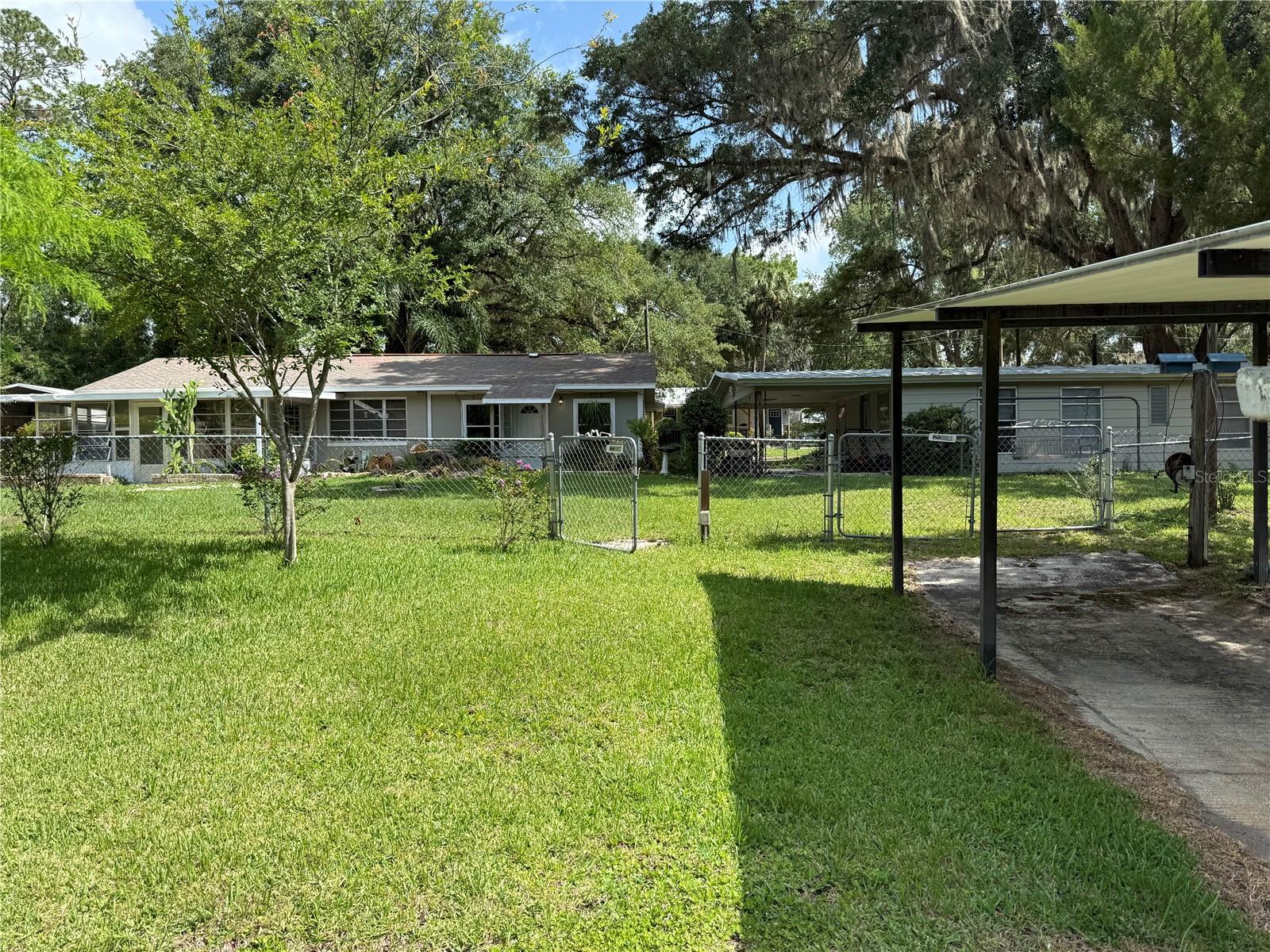 Rare Find! Sportsman's Paradise! Big Lake Kerr access from this canal front 2 Bedroom 2 Bath home located in the hidden community of Point Pleasant near Salt Springs. The home is in very good condition with large rooms, perfect for those family get togethers. There is a large screen room overlooking the water. There is even another 2 bedroom, 1 and 1 1/2 bath home on the property (currently being used as a shop) with it's own power, well and septic. Needs work but lots of potential. Beautifully landscaped large chain link fenced yard with majestic live oaks. 135' OF WATER FRONT WITH SMALL BOAT RAMP AND OPEN DOCK READY FOR YOUR PONTOON, FISH OR SKI BOAT. All this hidden in the Ocala National Forest.