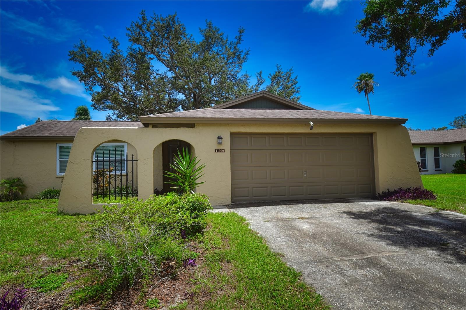 Location, Location, Location! This charming three-bedroom, two-bath home is perfectly situated just one block from the Pinellas Trail, tucked away on a peaceful, high & dry cul-de-sac. Surrounded by top-rated schools and just minutes from our award-winning beaches, this home offers the ideal blend of comfort and convenience. Upon entering the home, you'll be welcomed by neutral, easy-to-maintain tile flooring that flows throughout most of the main living areas. Step into the cozy living room- an ideal space for relaxing or enjoying movie nights with loved ones. Just around the corner, the updated kitchen awaits, making popcorn runs quick and easy! The kitchen features rich wood cabinetry, granite countertops, and sleek stainless-steel appliances. There is also a quaint eat-in area with sliding glass doors that open to the backyard-perfect for indoor-outdoor entertaining. The bedrooms are thoughtfully tucked away on the opposite side of the house, offering privacy and a quiet retreat. The updated hall bathroom serves guests and the secondary bedrooms, while the primary bedroom features its own updated en-suite bathroom and a private sliding glass door that opens directly to the backyard; great for enjoying a peaceful morning cup of coffee. And lastly with plenty of room to play, relax or entertain, the backyard is a blank canvas for your outdoor dreams! Call to see this home today, it will not last long.