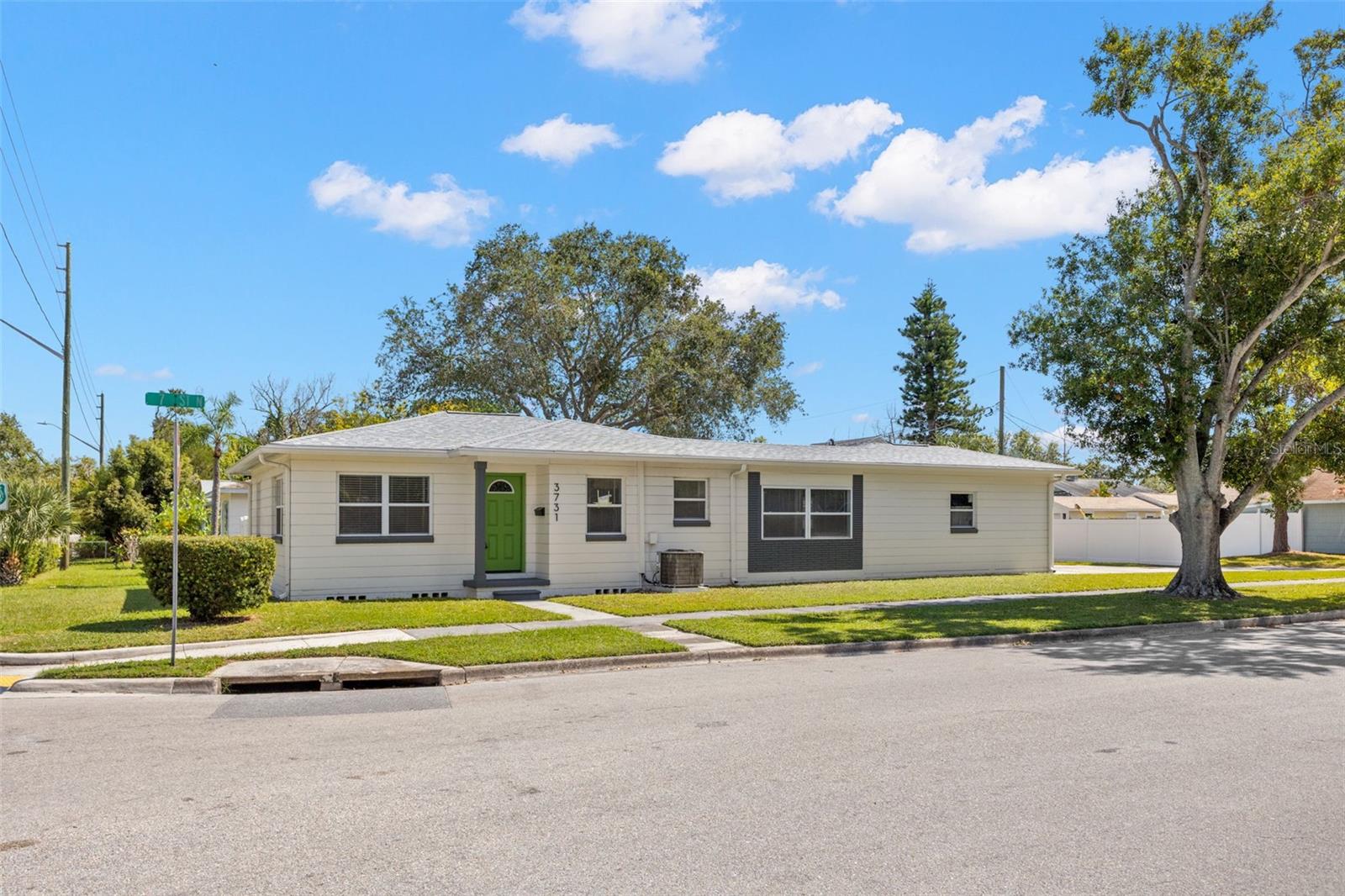 This conveniently located home is perfect for rental income, upsizing, or downsizing! Nestled on a spacious CORNER LOT in an X flood zone, this block construction beauty shines with a NEW ROOF (October 2025), luxury vinyl floors that flow seamlessly throughout, a hallway nook (perfect home office!), and galley kitchen boasting quartz countertops, shimmering glass subway tile backsplash, shaker-style cabinets, single tub stainless steel sink, and stainless steel appliances. Enjoy meals in the sunlit eat-in space in kitchen. Retreat to two generous bedrooms with an overhead cedar closet for storage, plus a pristine bathroom featuring single vanity, decorative lighting/mirrors, and tub/shower combo. The BONUS room off the rear is a versatile dream to use as den, office, library, media room, family room, or playroom. Additional features include central AC with digital thermostat, recessed lighting, NEWER water heater (2023), 2-CAR carport for ample off-street parking, alley access, covered front porch, freshly painted interior, updated windows, and a storage garage w/impact-resistant door. Privacy awaits behind the vinyl privacy fence, enclosing a paver patio area, green space for pets, and storage shed. No HOA means freedom! Discover effortless living in the bustling St. Pete centrally located to downtown, shops, restaurants, schools, parks, hospitals, interstate, airport, golf courses, boat ramp and more. Schedule your tour today and claim your slice of St. Pete paradise!
