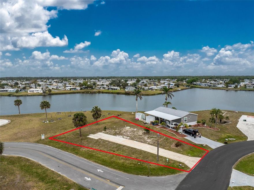 WATERVIEW CORNER LOT LOCATION, LOCATION, LOCATION! Don’t miss this rare opportunity to own a prime 9,147 sq ft waterview corner lot in the highly sought-after 55+ community of Lemon Bay Isles. Perfectly positioned on a quiet county maintained street and just 3 lots from the clubhouse, this cleared and ready-to-build lot offers the ideal blend of privacy, scenic beauty, and convenience. Enjoy peaceful water views, brilliant sunsets, and local wildlife from your future Florida dream home. Water hookups are already in place, and the current owner continues to pay the monthly water bill—saving you thousands in impact fees with Englewood Water District. Fast-track your Florida lifestyle with a modern, energy-efficient home tailored to your needs. As a resident of Lemon Bay Isles, you’ll enjoy a variety of amenities designed for an active and social lifestyle: heated community pool, tennis courts, shuffleboard, horseshoes, putting green, and a clubhouse filled with frequent social events and activities. And with this lot being just a short walk away from all of it, you’ll enjoy maximum convenience with minimum maintenance. Located in the heart of Englewood, you’ll have easy access to Walmart, Publix, gas stations, pharmacies, and medical facilities like HCA Florida Englewood Hospital and Englewood Healthcare & Rehabilitation Center. You’re also just 4 miles from Englewood Beach and minutes from local marinas, parks, the Edgewater Club, YMCA, and a variety of restaurants and entertainment options. With a low annual HOA fee of only $50, this vibrant 55+ community offers affordable coastal living at its finest.  Whether you’re seeking a winter getaway or full-time paradise, this lot—with its unbeatable location and new home promotion—is your chance to make it happen. Call today for details and to schedule your private showing—your Florida dream is waiting!