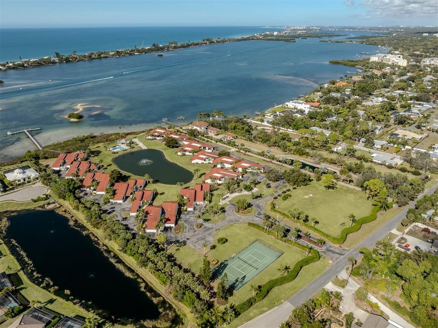 One or more photo(s) has been virtually staged. Live the Florida dream on the water! Wake up to shimmering bay views, spend your days boating and fishing, and end every evening with breathtaking sunsets over Little Sarasota Bay, all from this rarely available, maintenance-free waterfront villa. In the exclusive Heron Bay Club, an intimate bayfront enclave of just 25 villas set across 10 beautifully manicured acres, this home offers the ultimate Florida lifestyle. Enjoy resort-style amenities including a heated waterfront pool, tennis courts, kayak launch, fishing pier, and community docks with water and electric. Best of all, there are 10 free boat slips with no fixed bridges to the Gulf, making this a boater’s paradise, so bring your boat and go! This spacious two-bedroom, two-bath villa features sweeping views of Little Sarasota Bay, the Intracoastal Waterway, the community pond and pool. The open concept floor plan is enhanced by 15-foot ceilings, abundant natural light, and seamless indoor-outdoor living. Relax on the screened lanai, cool off in your heated waterfront pool and enjoy nightly sunsets that never get old. A private gated courtyard entry sets the tone for this unique home, complete with a new paved walkway and pet-friendly artificial turf, completely maintenance-free. Inside, enjoy ES Prestige impact-rated windows and sliding glass doors, all-new kitchen appliances, and an eat-in kitchen overlooking the courtyard. The primary suite offers lanai access through sliding glass doors and features two custom walk-in closets. The second bedroom also opens to the private courtyard and includes its covered lanai, perfect for guests or a home office retreat. Conveniently with quick access to Interstate 75, shopping, dining and beaches, this exceptional waterfront villa delivers boating, fishing, views and effortless Florida living in one remarkable package. A rare opportunity, this is waterfront living at its finest. Schedule your private showing today.