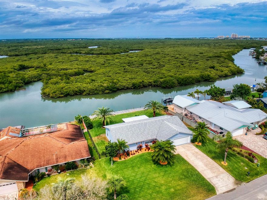 Welcome home to 210 Quay Assisi! This immaculate move in ready waterfront home boasts unobstructed views of the waterway that connects to the Indian River.  Tiled throughout, its bright and spacious split bedroom floor plan, this 3 bedroom 3 Bath home is ideal for entertaining or just relaxing and basking in warm breezes and some of Florida’s native marine wildlife.  The kitchen is the heart of this home and its easy to work in design offers lots of storage space and stunning granite counter tops and a window over the double sink overlooks the water while a small breakfast bar overlooks the  dining room and living area which offers access to the screened in patio, fenced in back yard and most importantly to the dock through sliding doors.  Other features include 2 car garage, updated counters and bath fixtures and of course excellent LOCATION in Venezia! A voluntary HOA offers those who opt to participate access to a tennis court and all just a short drive to down-town Canal St, entertaining Flagler Ave. or the shimmering sands of the Atlantic Ocean.  A water lovers dream home awaits. ;Water: City