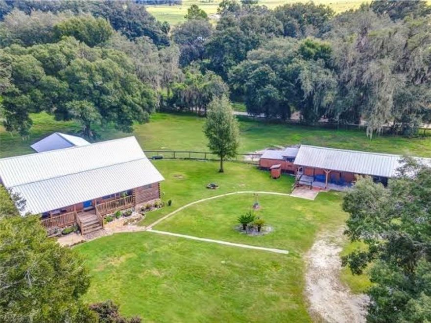Beneath a canopy of grand oaks, at the end of a winding, tree-lined drive, this 6.7-acre retreat in Bushnell offers a rare sense of peace, just minutes south of the World Equestrian Center.

The handcrafted log cabin blends rustic charm with comfort, featuring 3 bedrooms and 2.5 baths. Recently stained in July 2025, the home feels both timeless and refreshed.

Designed for a true country lifestyle, the property includes a five-stall barn, chicken run, and wide-open space for horses, homesteading, or simply enjoying quiet, natural surroundings. A separate ranch-hand or guest quarters adds flexibility for visitors or multi-generational living.

High and dry, thoughtfully maintained, and full of possibility, this is a place to slow down, breathe deeper, and live more intentionally.


Seller is offering $10,000 toward buyer concessions, adding even more value to this private countryside escape.