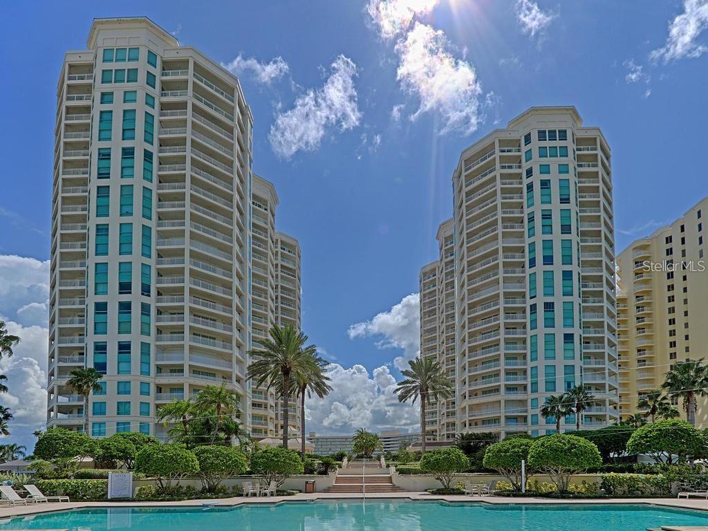 Luxury Gulf-Front FURNISHED Annual or Long-Term Rental at The Grande on Sand Key! 2 Bedrooms + A Den, 2.5 baths Live the ultimate coastal lifestyle in this 15th-floor home with 1952sf at The Grande, one of the most sought-after beachfront communities on Sand Key. Perfect for working at home or an EASY COMMUTE to Tampa and CLOSE to everything: shopping, dining, airports and much more.
Bask in the panoramic Gulf and Intracoastal views from floor-to-ceiling glass doors that open to a wrap-around private balcony. The light-filled interior features an open layout living and dining areas, comfortable furniture, a large homey kitchen, and amazing views from every room. Additional Features include an underbuilding GARAGE (coming soon -2nd level general parking for now), and resort Amenities with Two beachfront pools, huge outdoor spa, shaded cabanas, grilling pavilions, fitness center, pilates and barre room, tennis courts, billiard room, suana and steam rooms, social lounge, 24-hour security, and CONCIERGE SERVICES. Available NOW. Super easy rental process with knowledgeable staff ready to help. Schedule your private showing today!