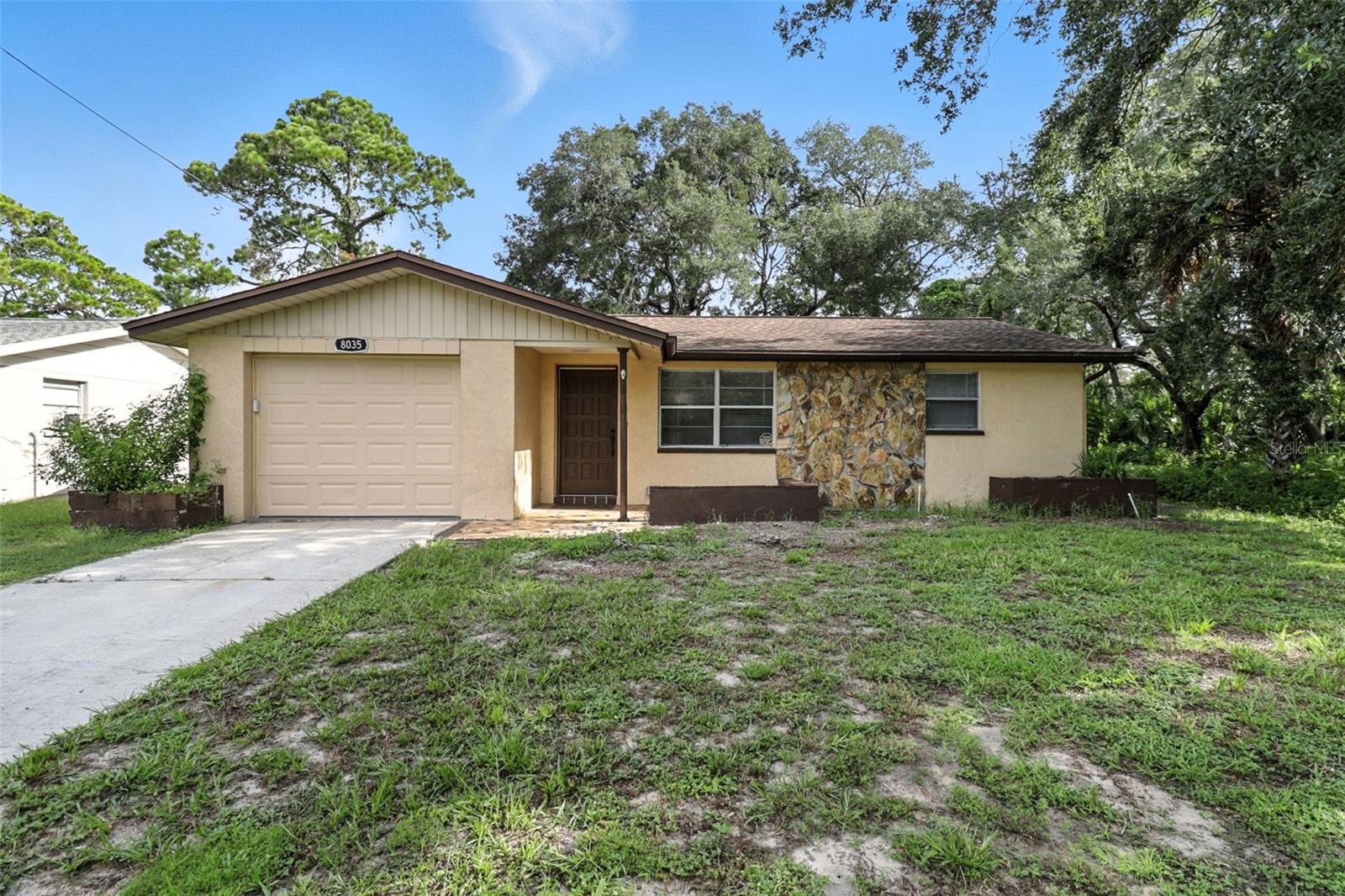 Welcome to this beautifully remodeled 2 bed, 2 bath home with a 1-car garage, featuring 1,024 sq. ft. of living space in the desirable Sea Pines neighborhood of Hudson, FL. The versatile back room adjacent to the kitchen can serve as a third bedroom or a dining area, offering flexible living options. This charming residence boasts a spacious yard—ideal for outdoor relaxation and entertaining. The open-concept kitchen highlights sleek white shaker cabinets, butcher block countertops, and a generous island, creating a modern and inviting space for cooking and gathering. It flows seamlessly into the living room, providing ample room for family and friends. Both bedrooms share a beautifully updated bathroom with a combined tub and shower. Additionally, the bathrooms have been renovated with new interior paint and wood look/ceramic tile flooring. The home’s AC was installed in 2022, and the roof was replaced in 2011 & New TANKLESS Water Heater was installed in 2025. The property was minimally impacted by the 2024 hurricane and requires flood insurance. The Sea Pines homeowners' association is voluntary, with no mandatory fees. Residents can enjoy the private park—perfect for fishing and relaxing—and access the boat ramp with direct Gulf access. An optional $100/year fee grants HOA membership, and a $50/year fee provides key fob access to the private boat ramp. Situated in a waterfront community renowned for stunning sunsets and outdoor recreation, residents can enjoy boating, fishing, and water sports in the Gulf of Mexico. A short boat ride takes you to nearby Anclote Island for a day of adventure. Just five minutes away by golf cart (allowed) is SunWest Park, a 70-acre spring-fed lake with white sandy beaches and a $30/year pass. The community offers a range of amenities, including SUPs, kayaks, obstacle courses, wakeboarding, and more through partnerships with The LIFT Adventure Park. Medical facilities and airports are conveniently nearby. Don’t miss this opportunity to own a beautifully updated home in Sea Pines and enjoy all that Hudson, Florida, has to offer. Schedule a showing today and start living the Florida coastal lifestyle!