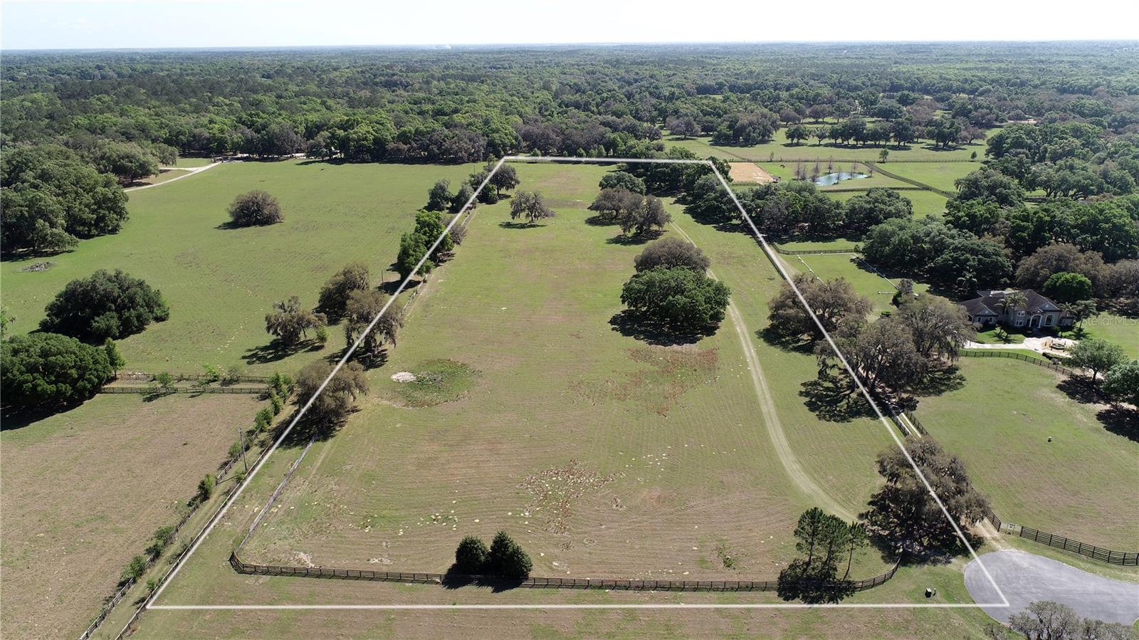 17.96 +/- Acres with the ability to ride to the Florida Greenways and Trails, plus close to the Florida Horse Park! It's a short 20-minute drive to WEC. Graced with Granddaddy Oaks and perimeter fenced sits this beautiful and waiting for the dream home or farm of your choice. This lot is located on a cul-de-sac in the back of the property for added privacy. Equine Estates is a gated community with bridle trails and requires a minimum of 3,000 SF of living area. This is one of the last lots available in the community.