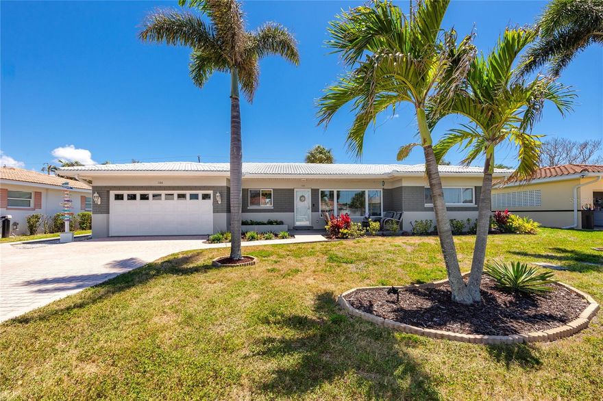 Belleair Beach is one of Pinellas County's quieter beach communities, a low-density residential enclave where the streets end at private beach access and the horizon belongs almost entirely to the residents. This two-bedroom, two-bath home sits 140 yards from that shoreline, close enough to hear the Gulf on a still morning and walk to the sugar sand in under three minutes.
The home was fully renovated in 2025 with new electrical, new HVAC, new luxury vinyl plank flooring through the main living areas, quartz countertops in both the kitchen and baths, updated vanities and fixtures, fresh interior and exterior paint, and a hurricane-rated garage door. The solid block construction from 1955 is the foundation; everything else is new. The kitchen pairs distressed gray cabinetry with white-veined quartz and a wine cork backsplash that reads as personal rather than produced. A built-in entertainment wall anchors the main living room.
A covered front porch frames the entry, and inside, the primary living space opens to a flex room separated by a custom barn door, appropriately sized for a dedicated home office, studio, or family room depending on the season. Oversized windows look directly to the fenced backyard, where a paver patio with string lights, a fire pit, and a convenient outdoor shower for post-beach cleanup creates the kind of outdoor setup that earns use well past sunset. Both baths have been fully updated with oversized walk-in showers, wainscoting, and sleek modern fixtures, and the primary suite connects directly to one of them. Both bedrooms are fitted with oversized built-in closets, custom organization systems, and over-closet storage consoles with the primary bedroom also boasting a separate cedar closet.
A two-car attached garage, paver driveway, and a lot at 8,000 square feet with room for a pool or further outdoor expansion complete the property. The park at 20th Street is a short walk and Intracoastal access sits nearby. The private beach entrance with fishing dock at the end of 19th Street belongs to residents alone. Belleair Beach enforces low-density residential zoning that keeps it exactly as it is, without high-rises or commercial development along the Gulf. Move-in ready and turnkey.
If a fully rebuilt home with thoroughly documented and permitted renovation in one of Pinellas County's most deliberately low-density beach communities, with private Gulf access, and nothing left to do besides adding your personal touches, is the right structure for where you're headed, this one is worth seeing in person.