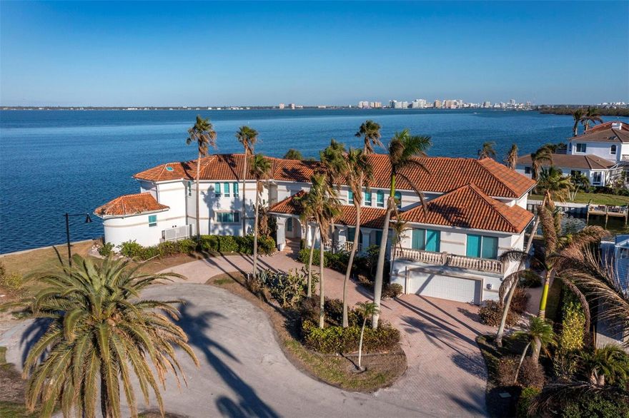 This is one of the most significant properties in the prestigious Country Club Shores community, boasting the third-largest lot in the neighborhood at an impressive 18,416 square feet. The current home spans 7,374 square feet, offering a spacious footprint that could be renovated or reimagined entirely as a custom-built waterfront masterpiece.
With expansive water frontage and direct access to Sarasota Bay, this property is a boater’s dream. The 275-foot seawall not only enhances the property's waterfront appeal but also provides ample space for multiple docks or larger watercraft. The oversized lot offers plenty of room to create luxurious outdoor living spaces, a pool, spa, and lush landscaping—all perfectly positioned to enjoy stunning water views.
Residents of Country Club Shores enjoy deeded beach access to the pristine sands of Longboat Key, perfect for peaceful strolls or relaxing sunsets. Optional membership to the nearby Longboat Key Club adds even more appeal, with access to championship golf courses, a world-class tennis center, a private marina, fine dining, and a luxurious spa.
Situated on the sought-after south end of Longboat Key, this property provides convenient access to St. Armands Circle’s boutique shops and restaurants, the cultural attractions of downtown Sarasota, and the mainland via the south bridge. Whether you envision a renovation or a brand-new custom home, 596 Yawl Lane is your opportunity to own a premier property in one of Longboat Key’s most desirable neighborhoods.