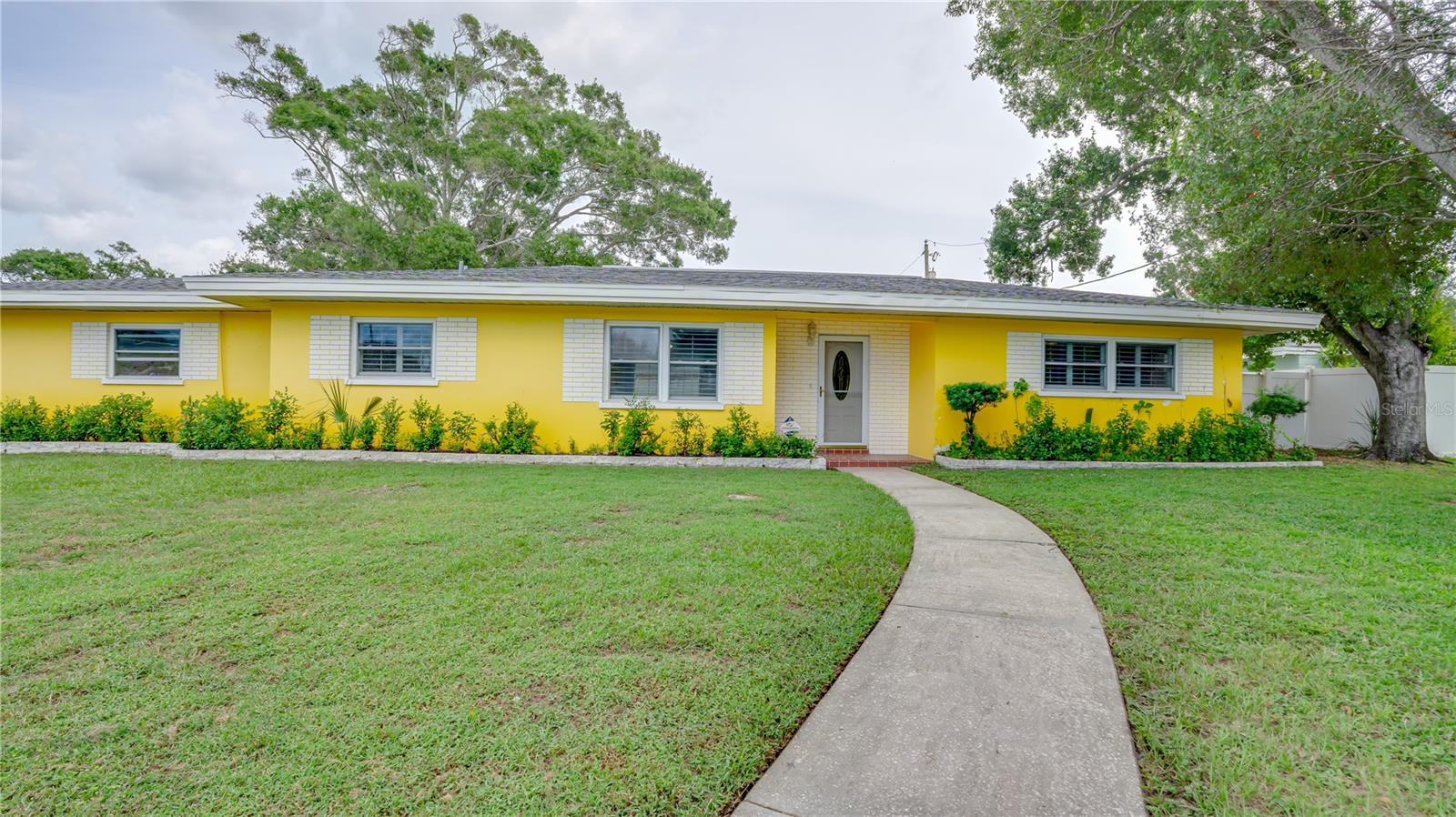 **Welcome to Your New Clearwater Retreat**Nestled in the desirable Chesterfield Heights neighborhood, this 3-bedroom, 2-bath ranch-style home is perfectly situated on a private corner lot in the heart of Clearwater. Built with block construction, this home offers timeless durability and great potential—making it an ideal opportunity to add your personal touch and create a true retreat.
Inside, you’ll find a spacious floor plan designed for both relaxation and entertaining. The home features classic terrazzo floors that can be beautifully restored, or you can easily update with your flooring of choice. Plantation shutters add charm throughout most of the home. The kitchen combines vintage character with modern updates, including original wood cabinetry, newer granite countertops, a stainless steel undermount sink, tile backsplash, and a convenient closet pantry. The roof, replaced in 2017, and the HVAC system, updated in 2016, are both in excellent condition. New electric panel (09/2025). Impact storm windows provide peace of mind and energy efficiency, while the oversized two-car side-entry garage offers additional convenience with washer and dryer hookups. The Florida room adds approximately 220 square feet of versatile living space, not included in the heated square footage, and can serve as an office, playroom, or hobby area. The family room is centered around a cozy wood-burning fireplace, perfect for cooler evenings.
The fenced backyard offers a large shed for extra storage or a workshop, along with plenty of room for outdoor living. On cooler Florida nights, it’s the perfect setting to relax by a fire and enjoy the privacy of your yard. Families will love the convenience of being just a short walk to Ponce De Leon Elementary and minutes from Eagle Lake Park, Highland Rec Complex, Largo Central Park, and other local favorites. Plus, Clearwater Beach is only 15 minutes away, with golf courses, shopping, and dining all within easy reach.