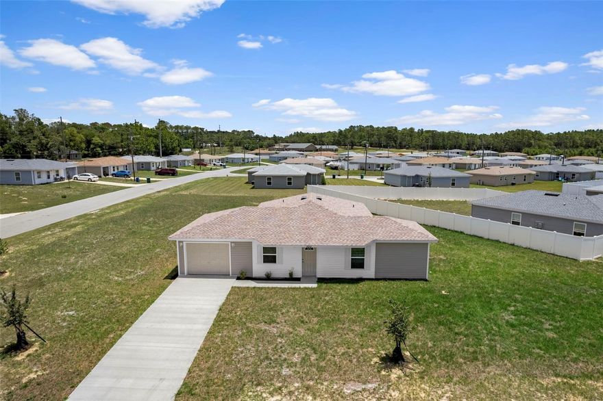 New construction, builder pays $7,500 in closing costs! This 4 bedroom home offers a lovely family-friendly floorplan, and is the lowest priced new home construction homes in Citrus Springs. Don't miss out on this very affordable home, fully equipped with all appliances including washer, dryer and refrigerator and also includes window treatments. This well built home showcases four ample sized bedrooms, two full baths, and a warm, cozy floor plan. The kitchen offers wood cabinetry, hard surface countertops, Frigidaire appliances, including the refrigerator. Throughout the home, you will love the ease of maintenance and the beautiful look of the luxury vinyl plank flooring. NO Carpet!! The inside laundry room is bright and cheerful, with a large window to bring in natural light and includes an Amana washer and dryer. It is truly move-in ready. For further peace of mind, the heat pump is a Trane, and the roof has 25-year shingles. You'll love the ease of maintenance, as well as the exterior siding. No painting! This home is situated on one of the largest homesites in the community, adding to the fantastic ambiance of this home and the fabulous price. There are no HOA fees, and Citrus Springs has a community center, tennis courts, and recreational activities for the outdoor enthusiasts. Citrus Springs is also located near freshwater fishing, biking trails, and a short distance away to Crystal River for saltwater fishing or swimming with the manatees. Don't miss out on this very affordable home, all appliances, and no HOA fees! Some photos are included of the furnished model of the same floor plan, so you can see how well this home lives. This home showcases Florida lifestyle living at a truly affordable price.
