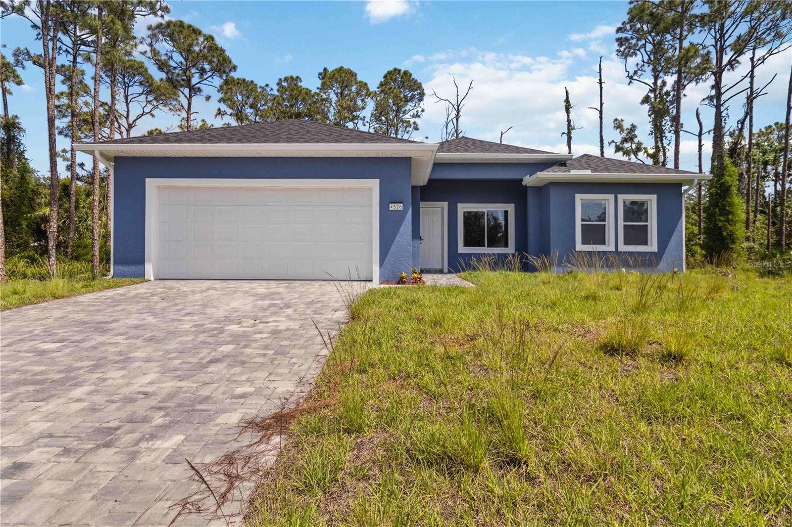 Welcome to your ideal Florida retreat in the thriving community of North Port! This newly built home offers a perfect blend of style, space, and modern comfort. Boasting 3 spacious bedrooms, 3 beautifully appointed bathrooms, and a separate home office, this residence sits on nearly a quarter-acre lot—providing the room and privacy you’ve been looking for.
Step inside to discover refined finishes throughout, including luxury vinyl plank flooring, recessed lighting, and abundant natural light pouring in from thoughtfully placed windows. The open-concept living space seamlessly connects to a chef-inspired kitchen, complete with soft-close shaker cabinets, premium fixtures, and eye-catching Port White Quartz countertops—ideal for both entertaining and everyday meals.
Energy-efficient and cost-conscious, the home is equipped with well and septic systems, helping to keep monthly expenses manageable. The outdoor space offers endless possibilities: envision a lush garden, custom patio, or future pool to make the most of Florida’s sunshine.
Additional perks include up to $7,500 in closing cost assistance for qualified buyers through an approved lender, and peace of mind with a 2/10 Home Warranty from the builder.
Nestled in a fast-growing area near top-rated schools, parks, shops, and restaurants, this home combines the convenience of city amenities with the tranquility of a quiet residential neighborhood. Thoughtfully designed and move-in ready, this North Port gem is waiting for you to call it home.