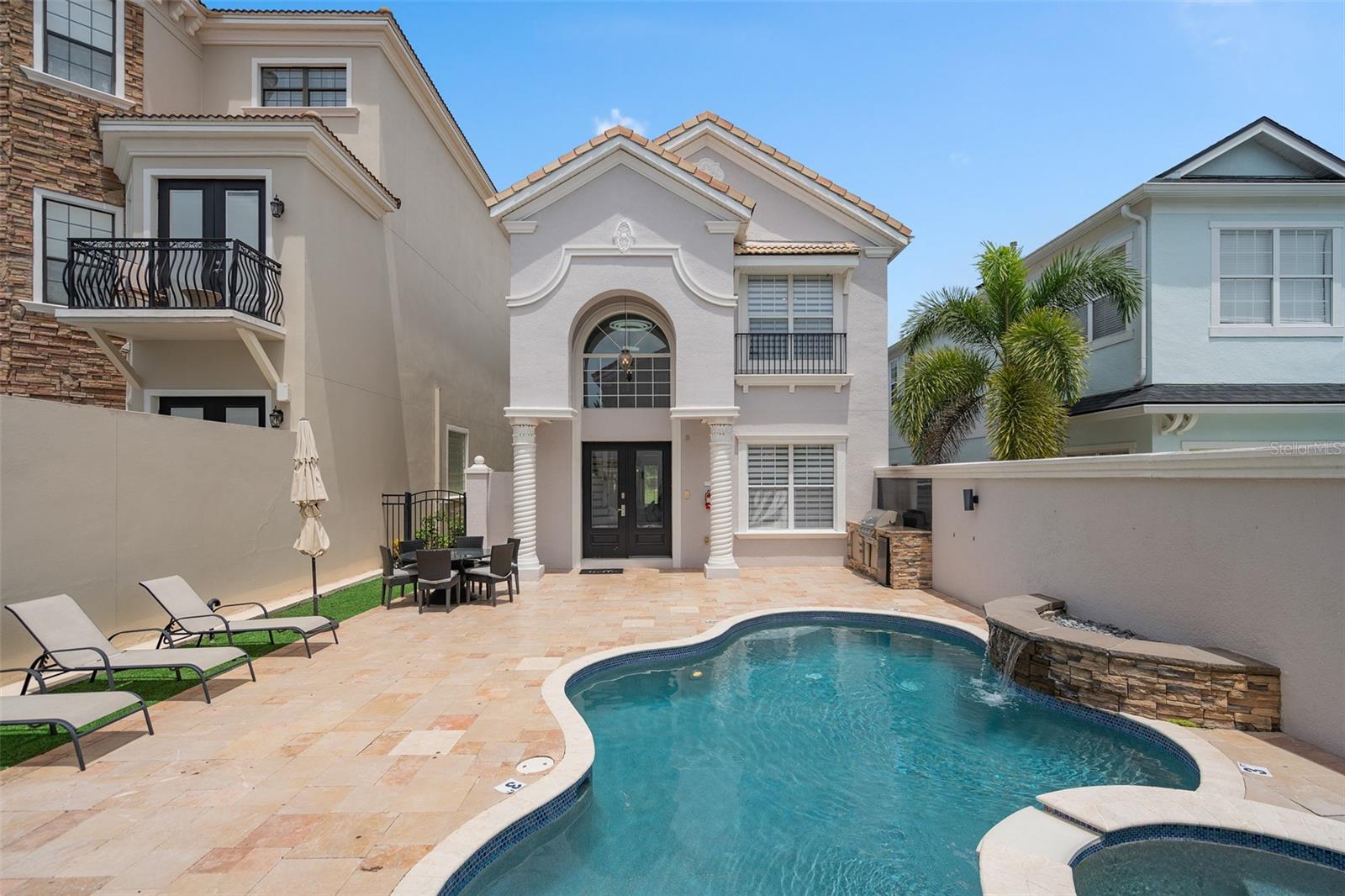 Active Club Membership! Offered fully furnished and turnkey! Positioned along the Arnold Palmer Legacy Golf Course, this 5-bedroom, 4.5-bathroom home offers panoramic water and golf views from multiple vantage points. Located near the center of Reunion Resort, the property provides quick access to the community’s restaurants and signature amenities. At the center of the home is a private courtyard featuring a heated pool, spa, summer kitchen, and outdoor shower. The main entry opens to a two-story foyer that leads to the kitchen, living and dining rooms, a powder room, and one bedroom suite with its own bathroom. Upstairs, the primary suite includes a cathedral ceiling, dual vanity, separate shower, soaking tub, and a private balcony overlooking the golf and water views. A third ensuite bedroom is also upstairs. The detached garage apartment, accessed from the courtyard, includes a kitchenette, two bedrooms, and a shared full bathroom, providing a private retreat. The 2-car garage has been converted into a media and game room, providing an additional 625 square feet of functional living space.
Spanning 2,300 acres just 7 miles south of Walt Disney World, Reunion Resort is the only destination in the world featuring 3 signature golf courses designed by Jack Nicklaus, Arnold Palmer and Tom Watson. Reunion is also home to the Leadbetter Golf Academy. Onsite dining options include Eleven, 7593 Chophouse, Traditions, Grande Lobby Sushi Bar, the Clubhouse, the Cove, and Drifters at the waterpark. The water park features a lazy river, slides, outdoor games, and an aquatic playground. The gift shop in the Grande offers sundries and Starbucks coffee. Complimentary shuttles to the Disney transportation and ticket center leave from the Grande daily. Additional amenities include Camp Reunion, the tennis and pickle ball center, bocce ball, miniature golf, foot golf, fitness center, playgrounds, dog park, various community pools including a roof top pool on the 11th floor of the Grande, and more. Zoning for short term rentals allows homeowners to rent their property by the night providing a great opportunity for investors. Reunion also works great as a primary residence or a private vacation retreat. The resort offers three separate 24 hour guard gated entries and one owner/resident only entry.
