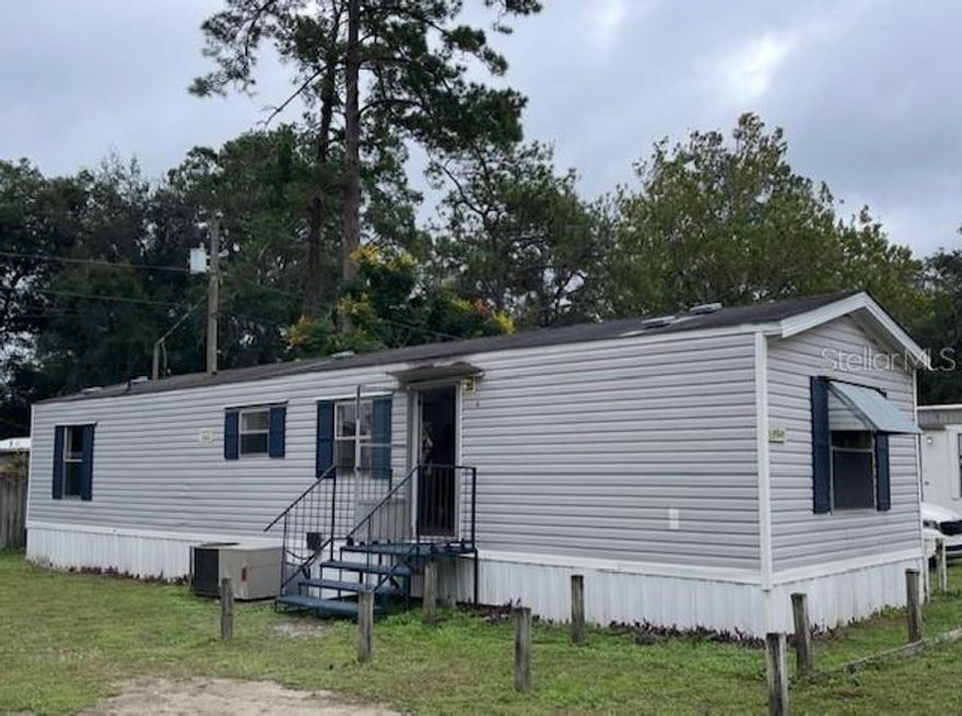 Value-Add Opportunity!  This mobile home park includes one SFR and 18 mobile homes (heated 552-924sqft), which produce a monthly income.  And 3 more pads are vacant but ready to be turned into 3 more income properties.  The SFR is currently occupied by the owner, with no income yet.  It could be rented out for a higher rent than mobile homes, as its heated square footage is 1,298, which is almost double that of mobile homes (monthly rent is among $550-$1,100). There are 2 bedrooms plus 2 bonus rooms, one serves as an office, and the other serves as a gym with AC and a closet in the garage.  You will see a swimming pool, 3 storage units, and some fruit trees in the yard.  The owner is very handy; he has plenty of parts, materials, tools, and equipment on the site for his D.I.Y. projects.  He installed security cameras and a system to guard the campus.  All the residents in the park use private water from a well; they recently replaced the motor, which could last for many years.  A septic system serves the MHP, with 3 drainfield covers that all the units in the park.  The owner is liable for the water and trash, while the tenants are liable for electricity and wifi.  The location, adjacent to US HWY 27, 301, 441, and SR 25, is very convenient for traveling anywhere.  It takes just 7 minutes to drive to Publix and other stores.  It attracts renters here.  The owner never pays for advertising for new tenants.  A sign and several referrals brought the new tenants in. Do you like to be the king or the Mayor of the territory?  Come to experience a new role, become the owner of the mobile Home park!
