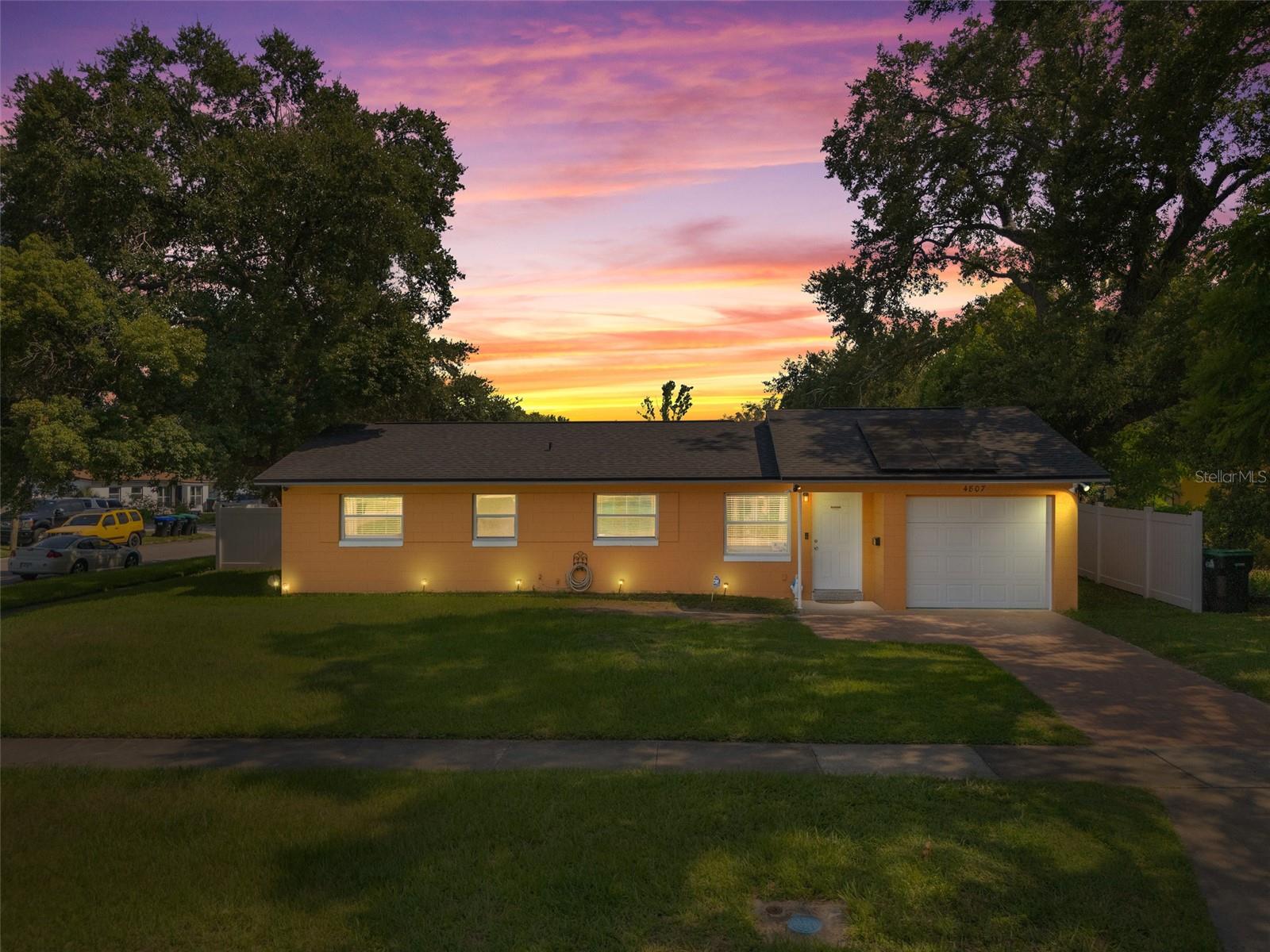 This wonderful 3-bedroom, 2-bathroom block home is nestled on a corner lot in the beautiful Conway Acres subdivision of Orlando. This quiet and peaceful neighborhood has NO HOA and is just minutes away from everything a home owner needs. The pride of ownership shows as soon as you park in the driveway and notice the UPDATED WINDOWS and the HURRICANE RATED GARAGE DOOR. As you enter the house and pass through the charming living room, you'll notice the wide-panel hard wood floors, and abundance of natural light filling the home. The kitchen has many updates including a CUSTOM RANGE HOOD venting outdoors, GRANITE COUNTERS, a customer STONE TILE BACKSPLASH, and an upgraded faucet! From the kitchen you will walk into the bonus/utility room that holds a new COMMERCIAL-GRADE WATER HEATER, a washer and dryer that both convey, a hand wash sink and wonderful storage areas. Both the primary and guest bath have been upgraded from top to bottom! Every bedroom has a ceiling fan and wonderful laminate flooring. The expansive back screen porch has a new PORCELAIN TILE flooring and comes with a wall-mounted flat screen TV! From the porch, you will see the fully-fenced large backyard providing ample space for sports, playgrounds, or a pool! The architectural shingle roof was in installed in 2022. The air conditioner was installed in 2020. The solar panels were installed in 2023 and have a monthly payment of $172. The last power bill was $12!!! To top it all off, the garage easily holds a full size vehicle, offers tons of storage, and has a brand new garage door opener! Come see this beautiful home and make it yours today!