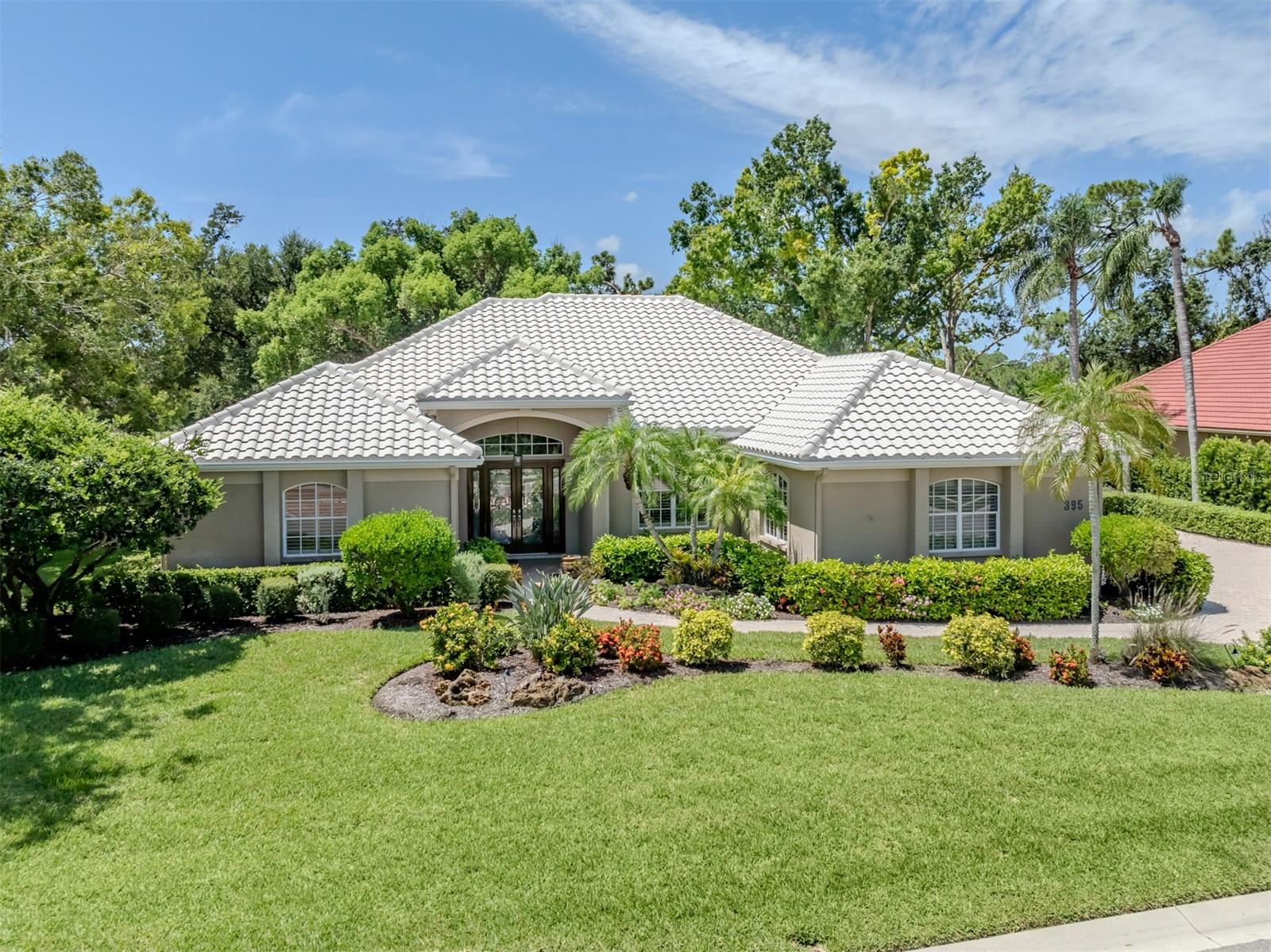 Stunning residence that's filled with natural light and thoughtful design in the prestigious, member-owned, gated community of The Venice Golf and Country Club. Curb appeal is exceptional with meticulously maintained landscaping, a side-entry three-car garage, and a generously sized paver driveway. Step through the refinished elegant leaded beveled glass doors into a bright and expansive open split floor plan. Soaring ceilings and organic bamboo flooring in the living room create a warm and inviting ambiance. At the heart of the home, the screened lanai with its heated pool and spa featuring a new pool and spa pump is perfectly positioned to capture serene views of the golf fairway and lush tropical preserve making it an ideal space for relaxing or entertaining. A chef's delight, the updated kitchen features wood cabinetry, a spacious breakfast bar, custom tile backsplash, and sleek satin-finish appliances. The adjacent family room centers around a striking fossil coral rock fireplace with a new propane system framed by tall beautiful, picturesque windows overlooking the fairway and the indigenous tropical preserve, filling the space with soft, natural light. Retreat to the luxurious primary suite that's accessed through double French doors and a decorative art-niche foyer. The en-suite bathroom features a Roman walk-in shower with custom tile inlay, a slipper soaking tub, dual quartz vanities with pendant lighting, a water closet, and three sizable closets for optimal storage. The second bedroom includes its own bathroom and dual closets, while the third bedroom is perfectly suited for use as an office or guest suite, complete with a private full bath and direct access to the pool and lanai. New HVAC system, newer roof, irrigation well replaced, interior painting and more. This home offers an exceptional blend of luxury, comfort, and privacy. Discover the unparalleled lifestyle of The Venice Golf and Country Club where extraordinary living begins. Recently reimagined, the expanded Clubhouse features a spacious gathering bar, gourmet and commercial kitchens, and a cozy fire pit. The new state-of-the-art Wellness Center offers massage therapy, fitness classes, yoga, physical therapy, and personal training, providing a holistic approach to health and well-being. Beautifully renovated Ted McAnlis-designed 18-hole championship golf course. Residents also enjoy Har-Tru tennis courts, pickle ball, bocce ball, and a Junior Olympic-sized pool and spa, balancing active living with relaxation. As a Geo-Certified Audubon Cooperative Sanctuary, VGCC embraces environmental stewardship and sustainability. With an A+ financial rating, the community is as solid as it is serene. Ideally located just minutes from airports, shopping, dining, I-75, cultural venues, and Wellen Park. It's also a short drive to the charming Venice Island, where 14 miles of pristine beaches meet the sparkling Gulf Coast.